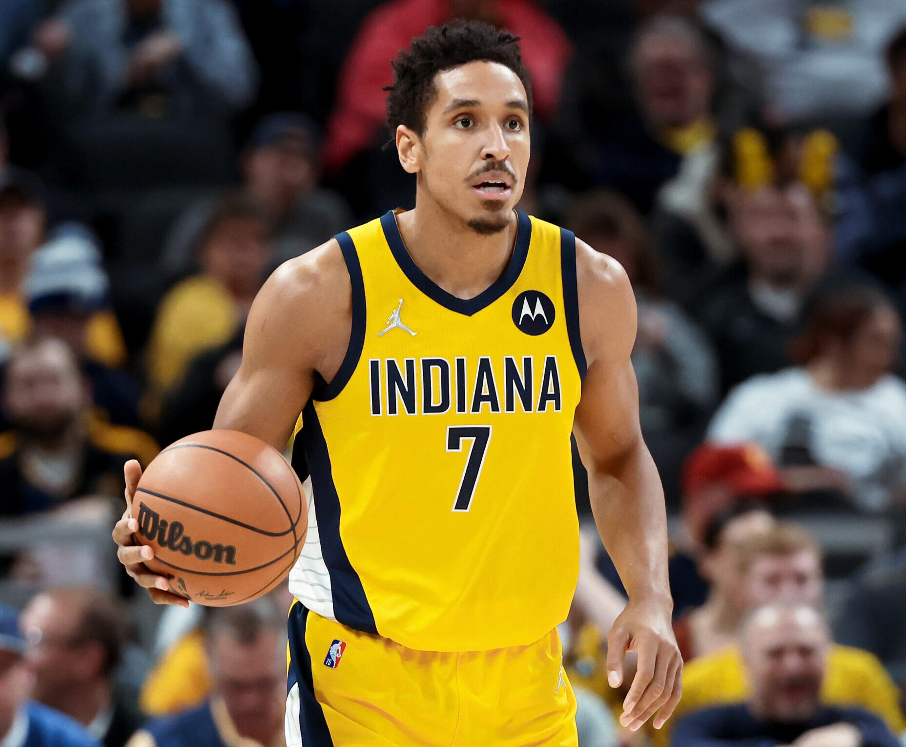 Malcolm Brogdon #7 of the Indiana Pacers dribbles the ball in the third quarter against the Toronto Raptors at Gainbridge Fieldhouse on November 26, 2021 in Indianapolis, Indiana.