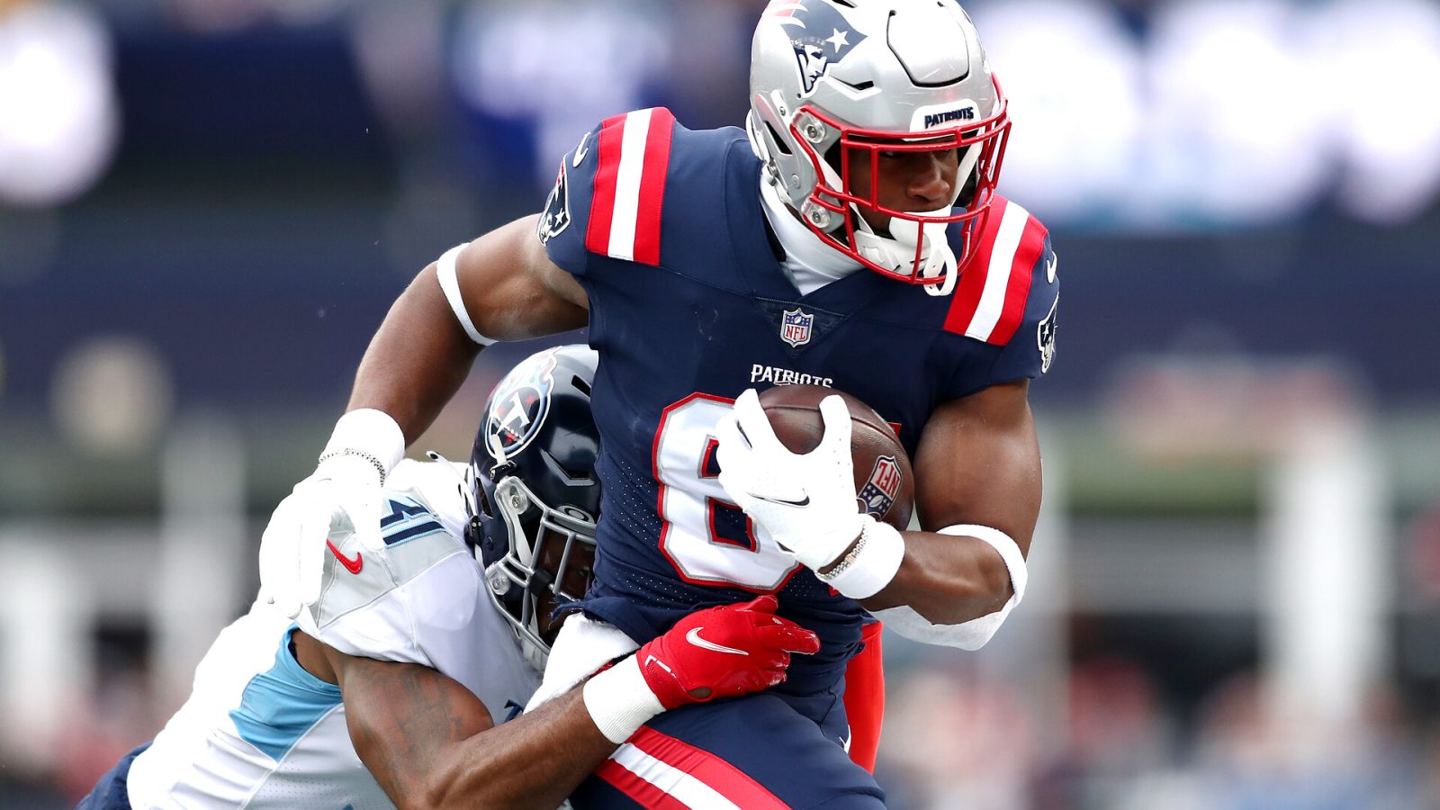 Kevin Byard #31 of the Tennessee Titans tackles Jonnu Smith #81 of the New England Patriots in the first quarter at Gillette Stadium on November 28, 2021 in Foxborough, Massachusetts.