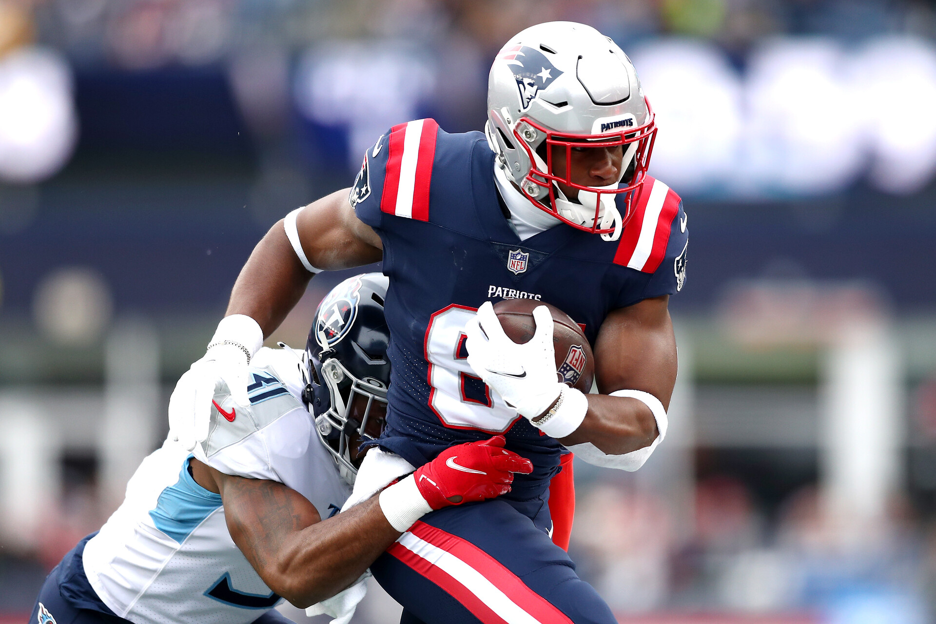 Kevin Byard #31 of the Tennessee Titans tackles Jonnu Smith #81 of the New England Patriots in the first quarter at Gillette Stadium on November 28, 2021 in Foxborough, Massachusetts.