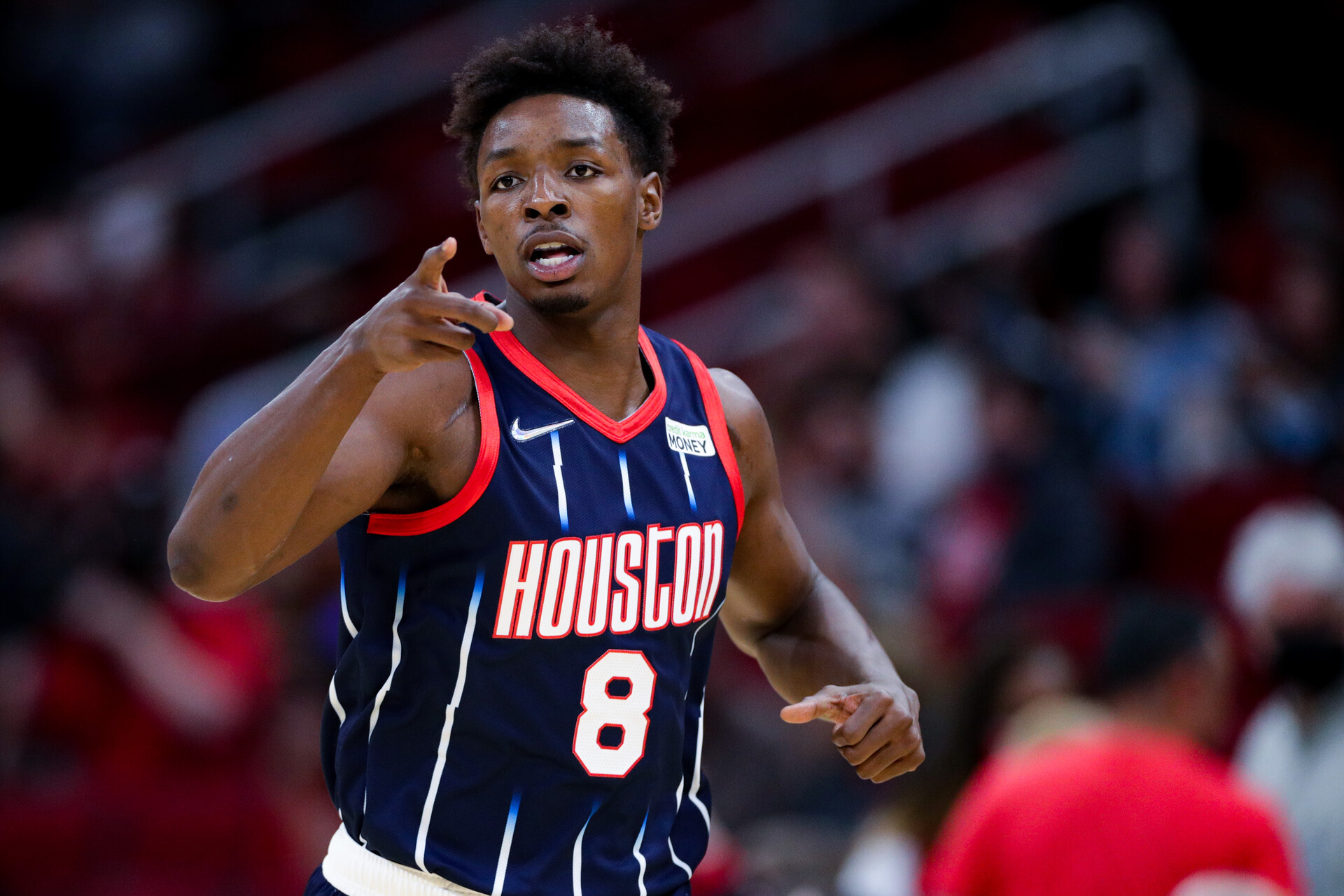 Jae'Sean Tate #8 of the Houston Rockets gestures to the bench after a basket during the first half against the Orlando Magic at Toyota Center on December 03, 2021 in Houston, Texas.