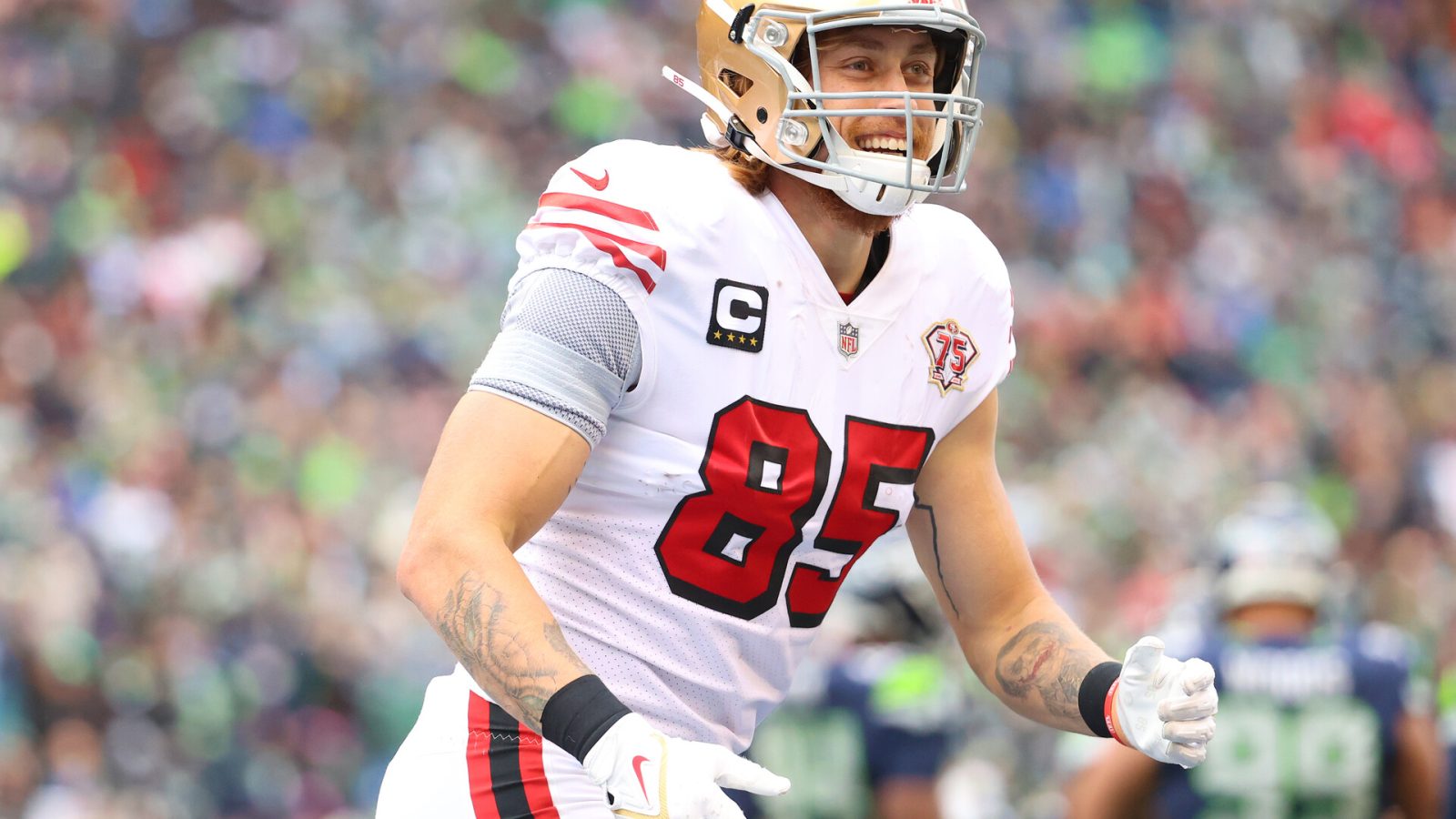 George Kittle #85 of the San Francisco 49ers celebrates after catching the ball for a touchdown during the first quarter against the Seattle Seahawks at Lumen Field on December 05, 2021 in Seattle, Washington.