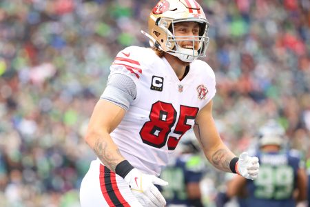 George Kittle #85 of the San Francisco 49ers celebrates after catching the ball for a touchdown during the first quarter against the Seattle Seahawks at Lumen Field on December 05, 2021 in Seattle, Washington.