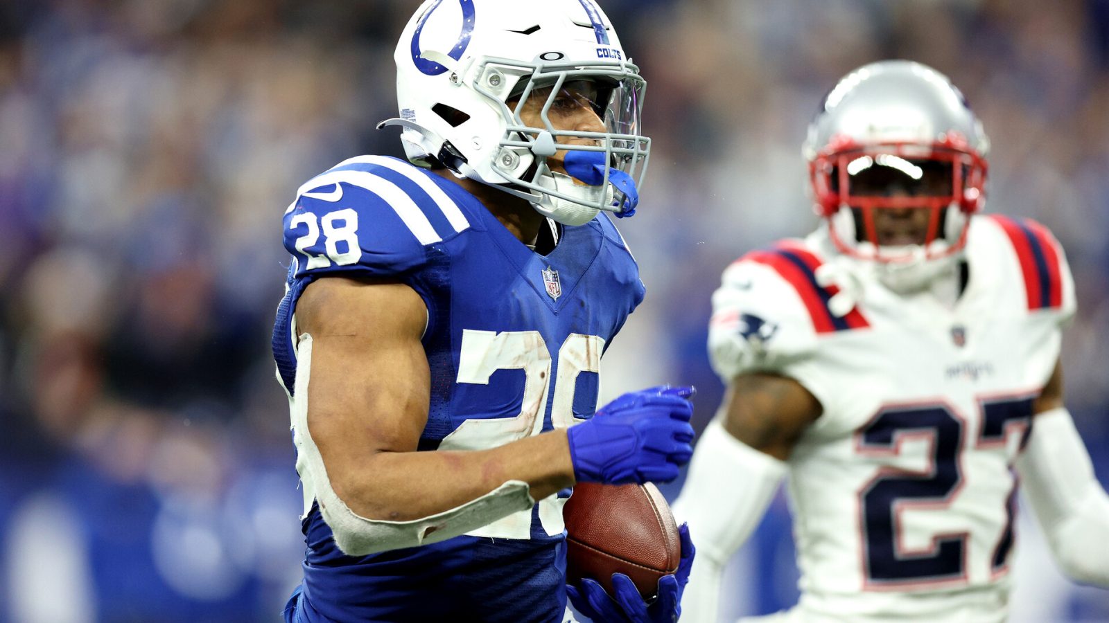 Jonathan Taylor #28 of the Indianapolis Colts rushes for a touchdown during the fourth quarter against the New England Patriots at Lucas Oil Stadium on December 18, 2021 in Indianapolis, Indiana.