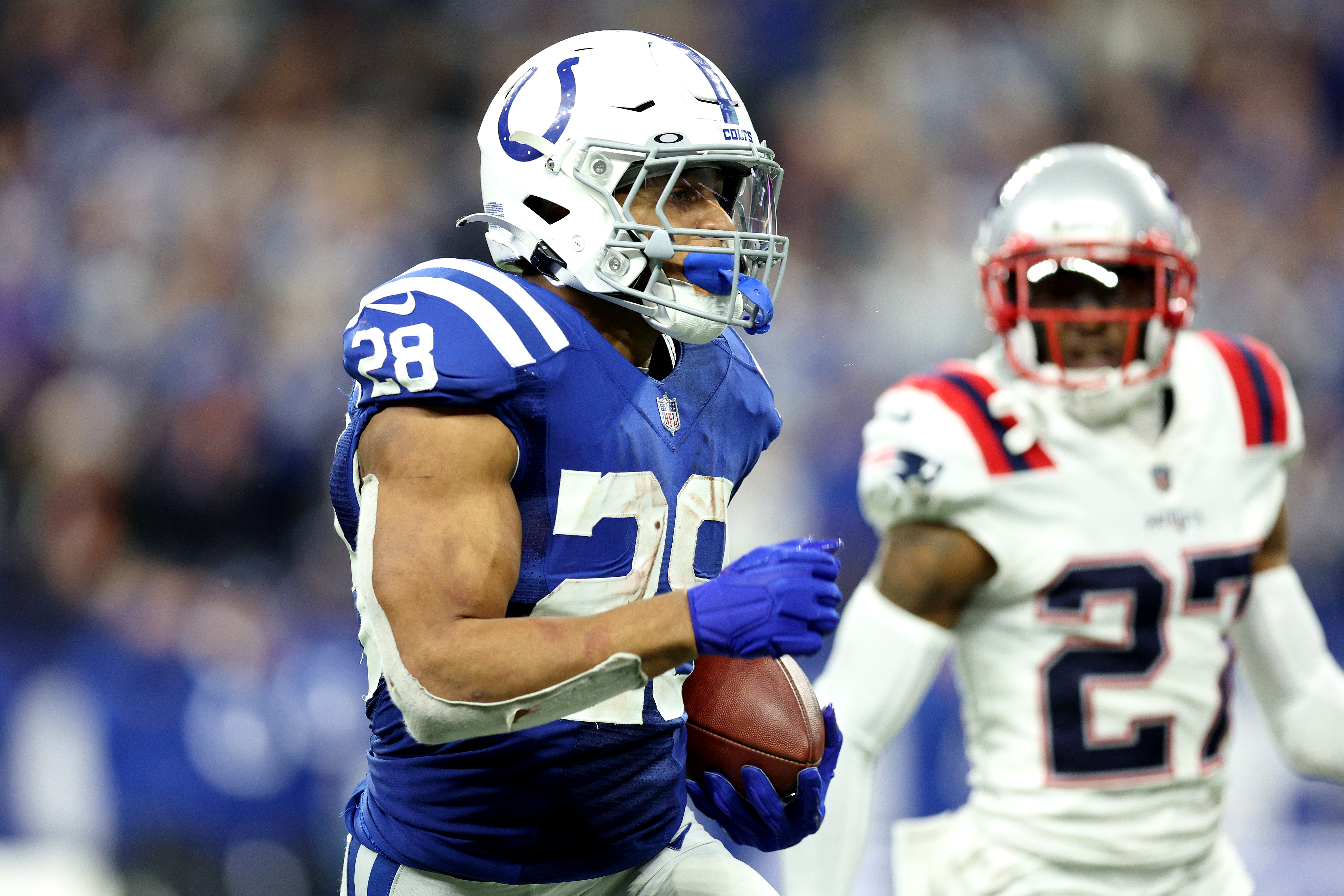 Jonathan Taylor #28 of the Indianapolis Colts rushes for a touchdown during the fourth quarter against the New England Patriots at Lucas Oil Stadium on December 18, 2021 in Indianapolis, Indiana.