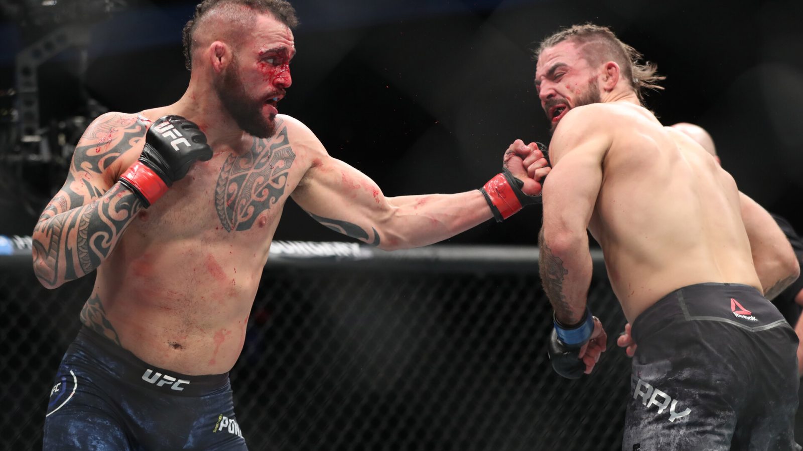 Santiago Ponzinibbio (left) throws a left uppercut at opponent Mike Perry during UFC Fight Night
