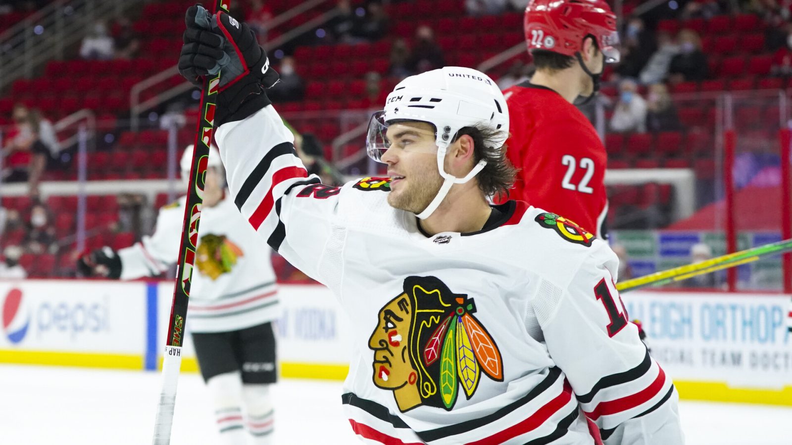 Chicago Blackhawks left wing Alex DeBrincat (12) scores his game winning overtime goal against the Carolina Hurricanes at PNC Arena.