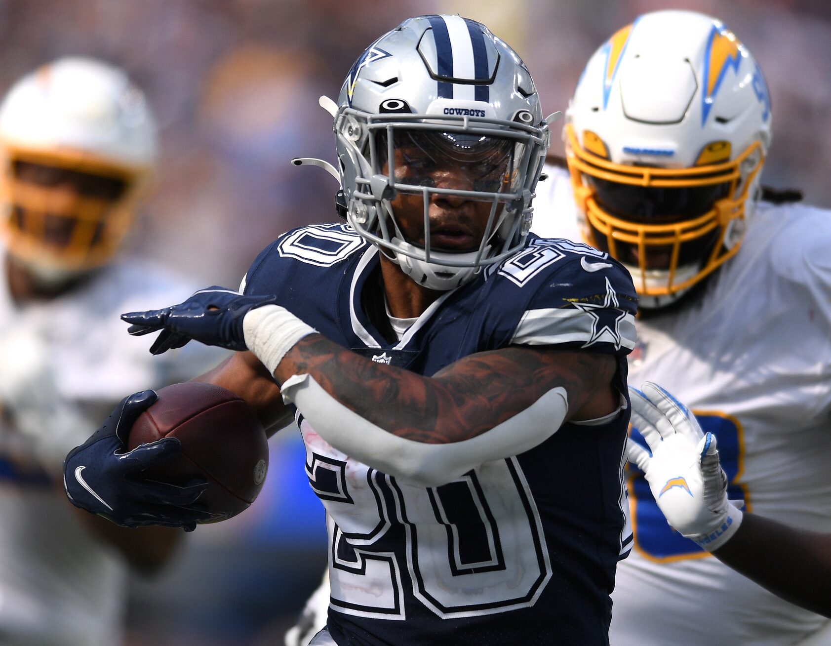 Dallas Cowboys running back Tony Pollard (20) runs the ball against Los Angeles Chargers linebacker Kenneth Murray (9) during the second half at SoFi Stadium.