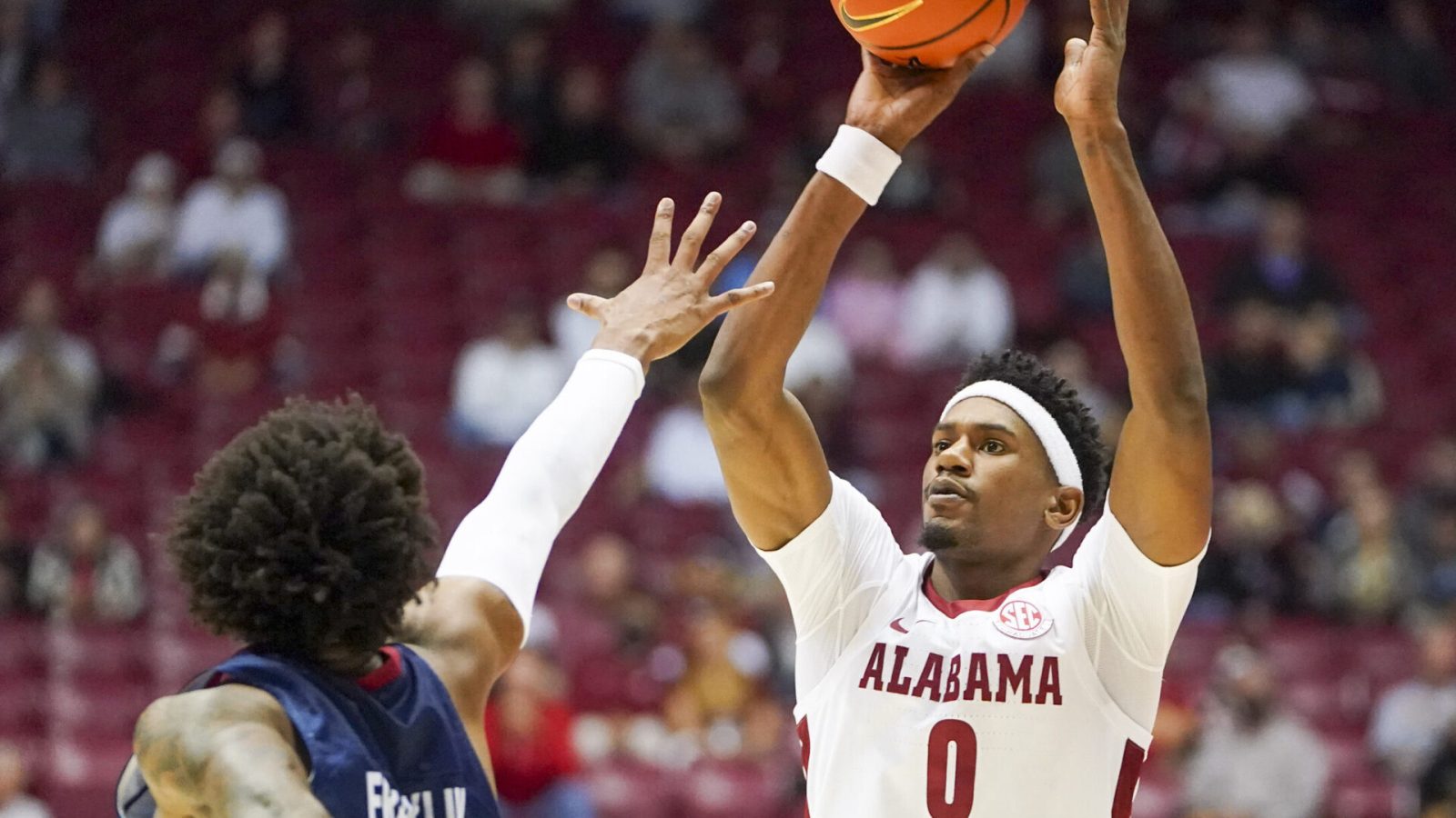 Alabama Crimson Tide forward Noah Gurley (right) shoots the basketball over South Alabama Jaguars forward Javon Franklin
