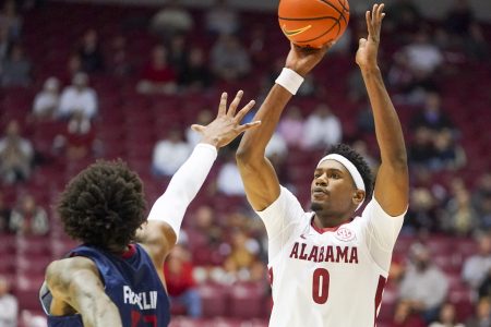Alabama Crimson Tide forward Noah Gurley (right) shoots the basketball over South Alabama Jaguars forward Javon Franklin