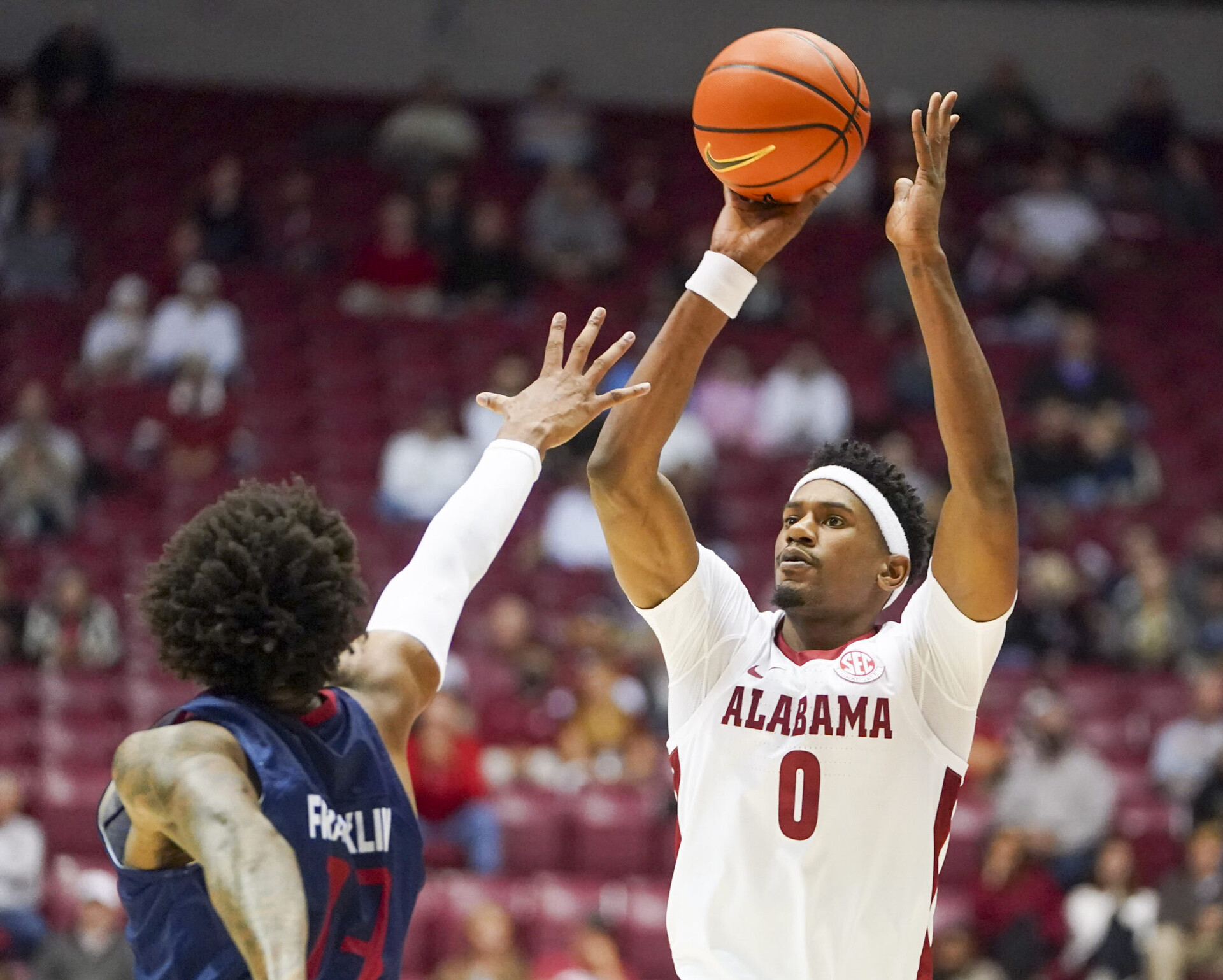 Alabama Crimson Tide forward Noah Gurley (right) shoots the basketball over South Alabama Jaguars forward Javon Franklin