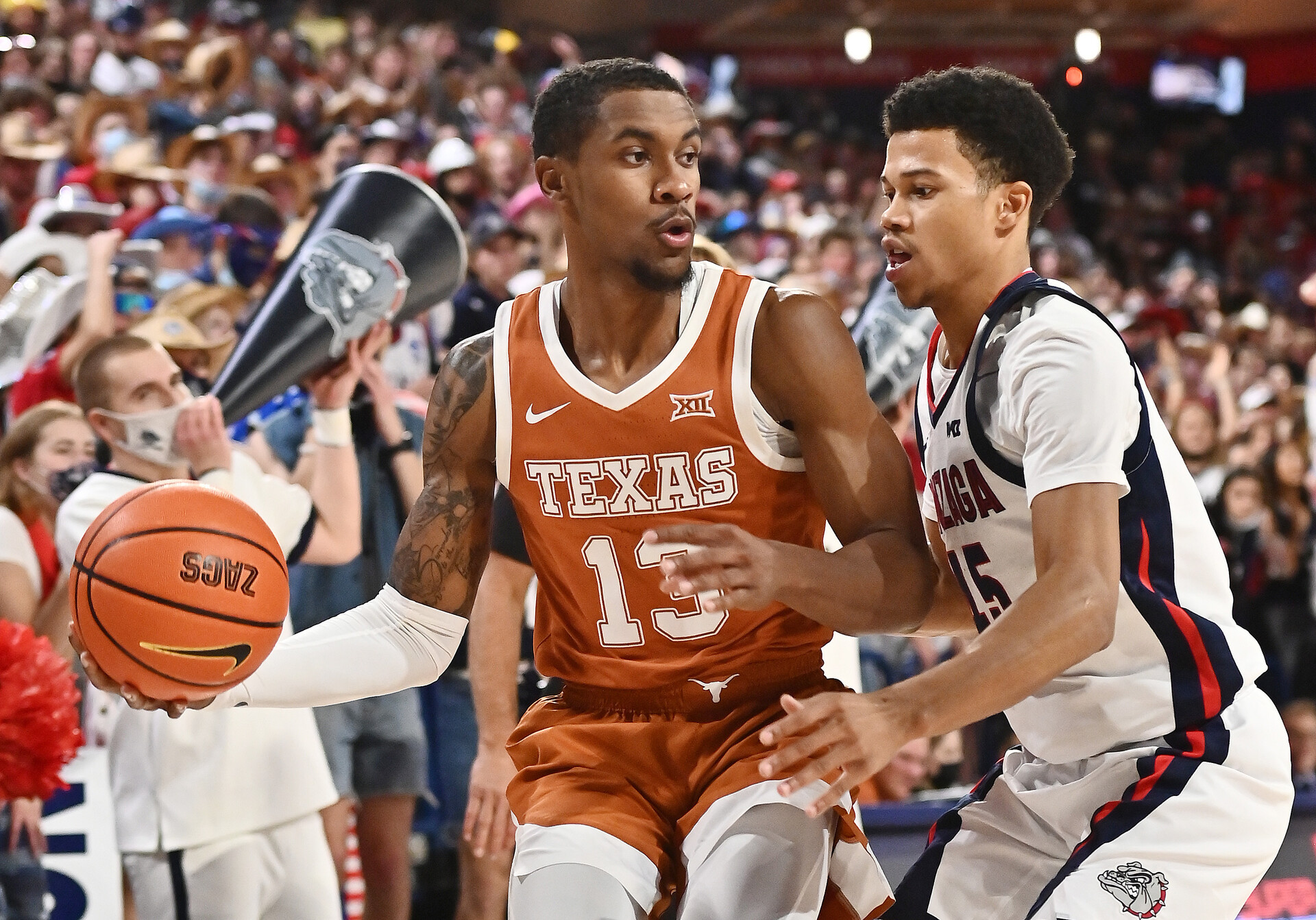 Saturday College Basketball Odds - Texas Longhorns guard Jase Febres (left) brings the ball down court against Gonzaga Bulldogs guard Rasir Bolton (right)