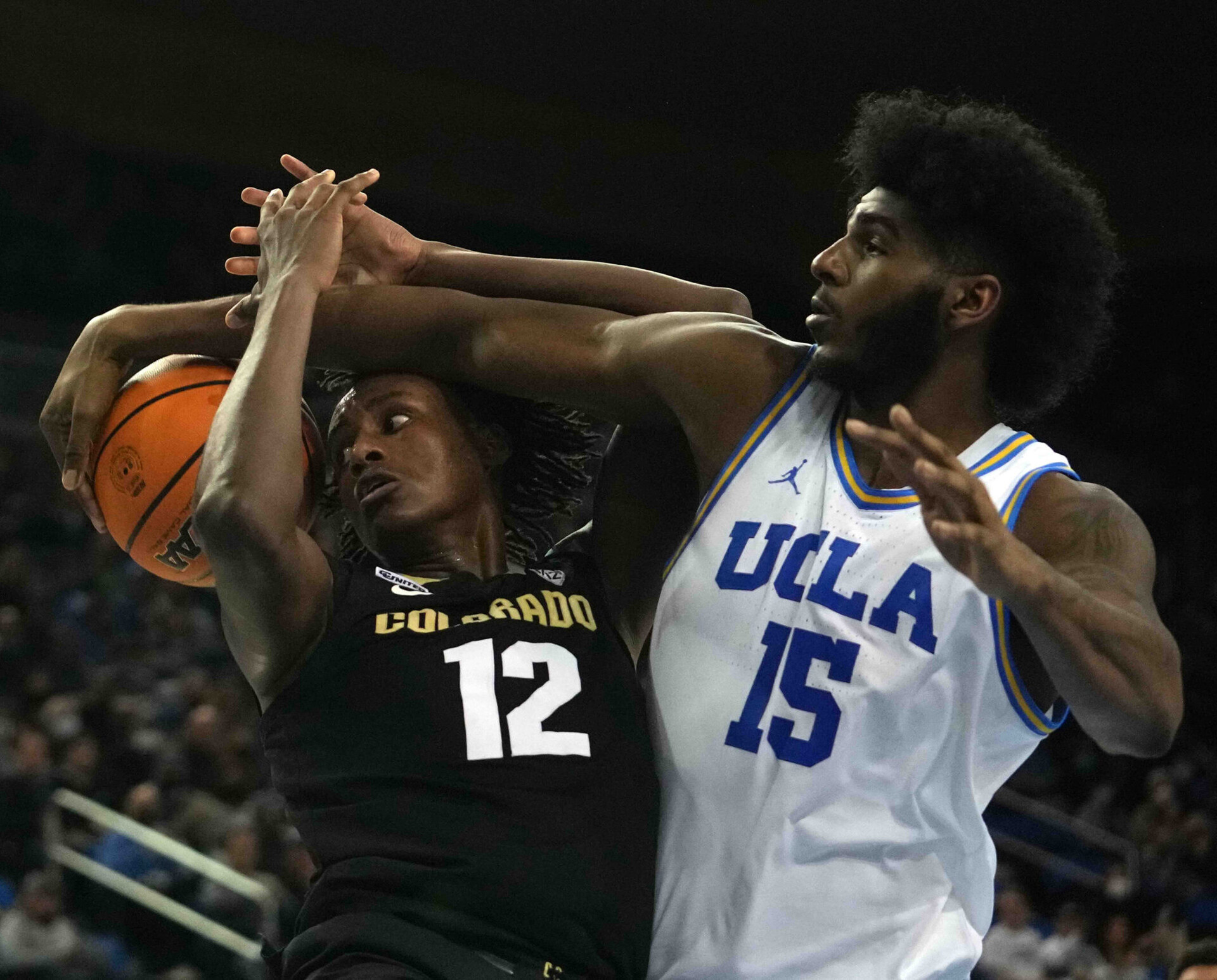 Dec 1, 2021; Los Angeles, California, USA; Colorado Buffaloes forward Jabari Walker (12) is defended by UCLA Bruins center Myles Johnson (15) in the first half at Pauley Pavilion.