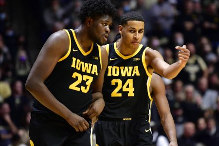 Iowa Hawkeyes forward Josh Ogundele (left) and Iowa Hawkeyes forward Kris Murray (right) have a discussion while walking back onto the court during a game against Purdue