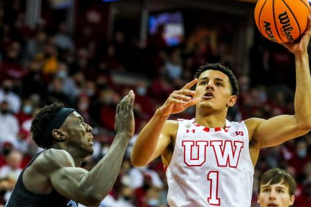 Wisconsin Badgers guard Johnny Davis drives to the basket as Marquette forward Kur Kuath defends