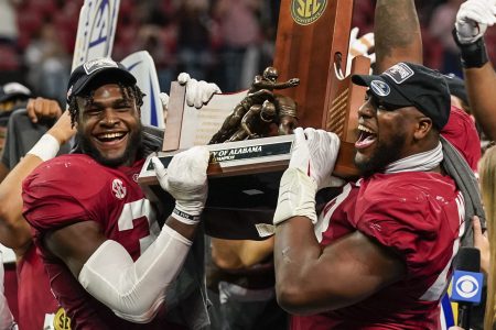Dec 4, 2021; Atlanta, GA, USA; Alabama Crimson Tide linebacker Will Anderson Jr. (31) and defensive lineman Phidarian Mathis (48) lift the trophy for winning the SEC Championship by defeating the Georgia Bulldogs at Mercedes-Benz Stadium.