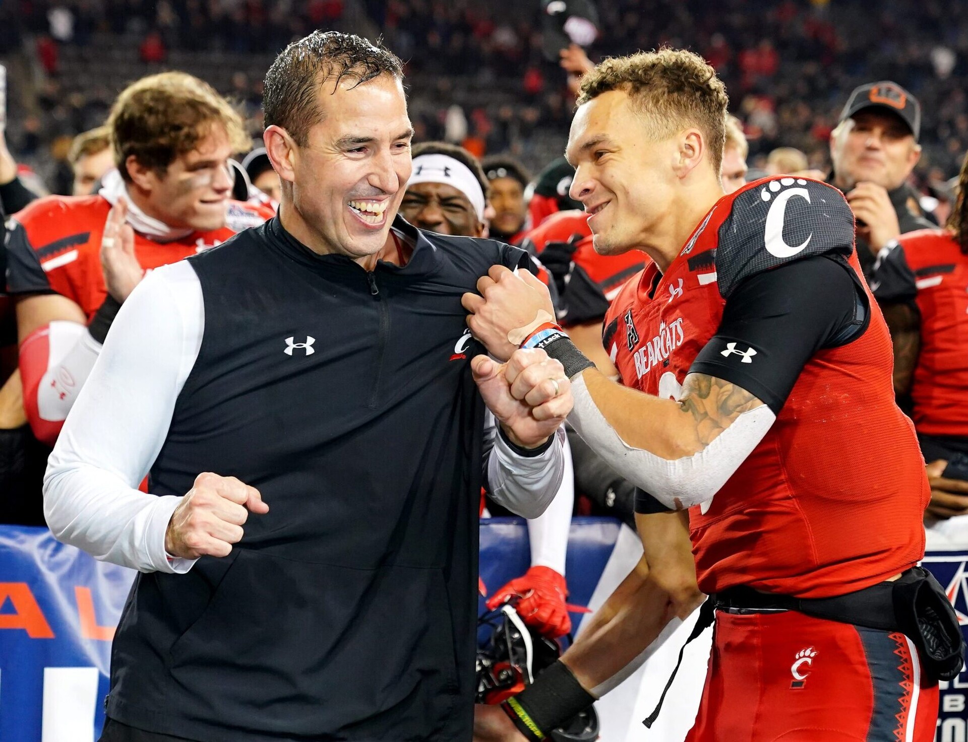 Cincinnati Bearcats head coach Luke Fickell, left, and Cincinnati Bearcats quarterback Desmond Ridder (9) celebrate the victory in the American Athletic Conference championship football game, Saturday, Dec. 4, 2021, at Nippert Stadium in Cincinnati. The Cincinnati Bearcats defeated the Houston Cougars, 35-20. Houston Cougars At Cincinnati Bearcats Aac Championship Dec 4