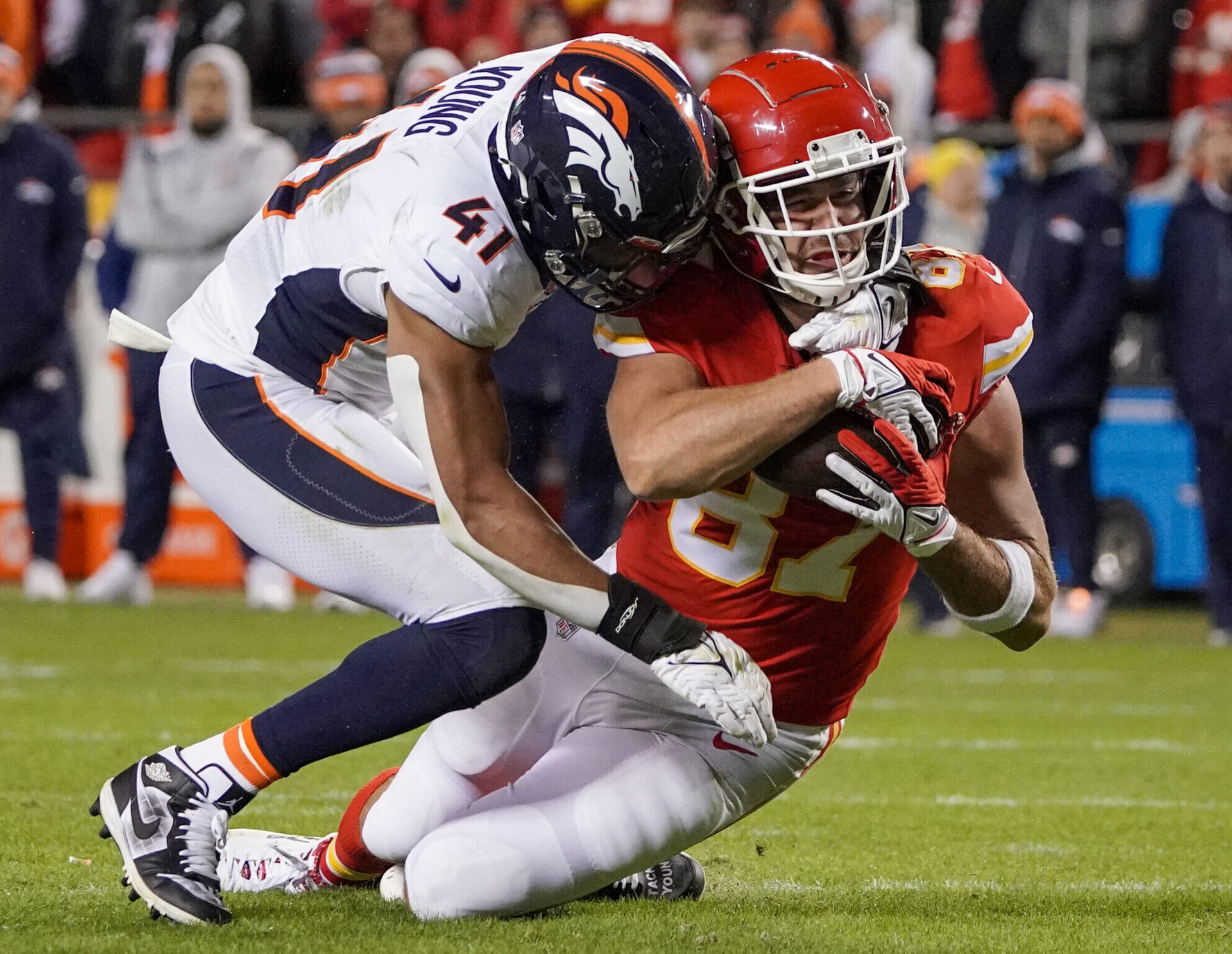 Denver Broncos linebacker Kenny Young tackles Kansas City Chiefs tight end Travis Kelce