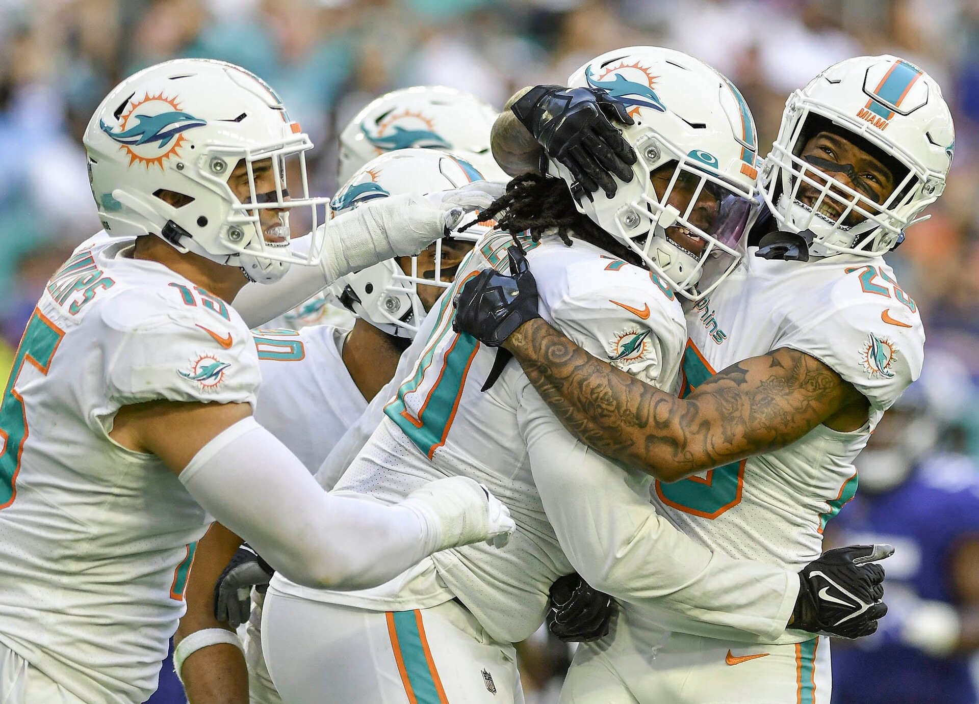 Miami Dolphins nose tackle Adam Butler (center) celebrates a sack with teammate cornerback Xavien Howard (right) during a game against the New York Giants