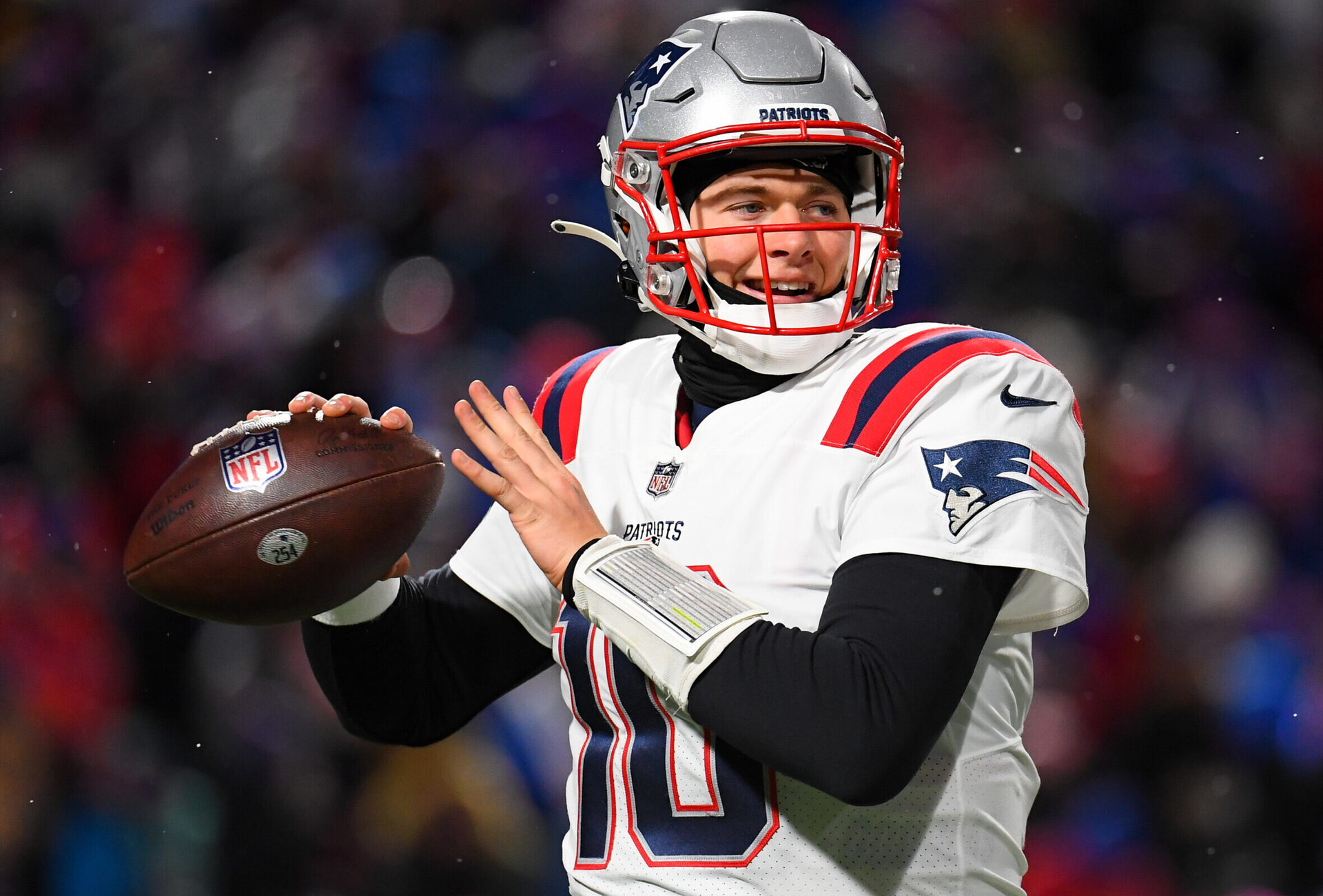 New England Patriots quarterback Mac Jones warms up on the field during a time-out against the Buffalo Bills