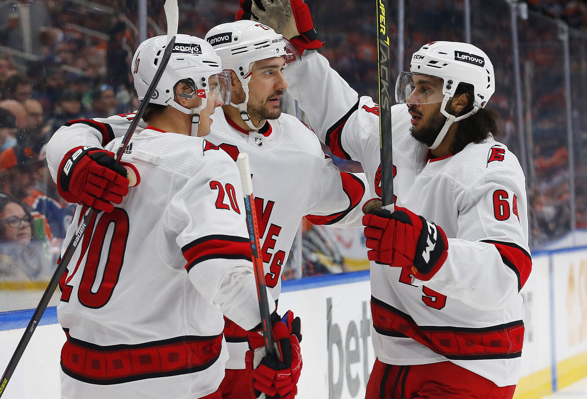 Carolina Hurricanes forward Nino Niederreiter (center) and two teammates celebrates Niederreiter's goal against the Edmonton Oilers
