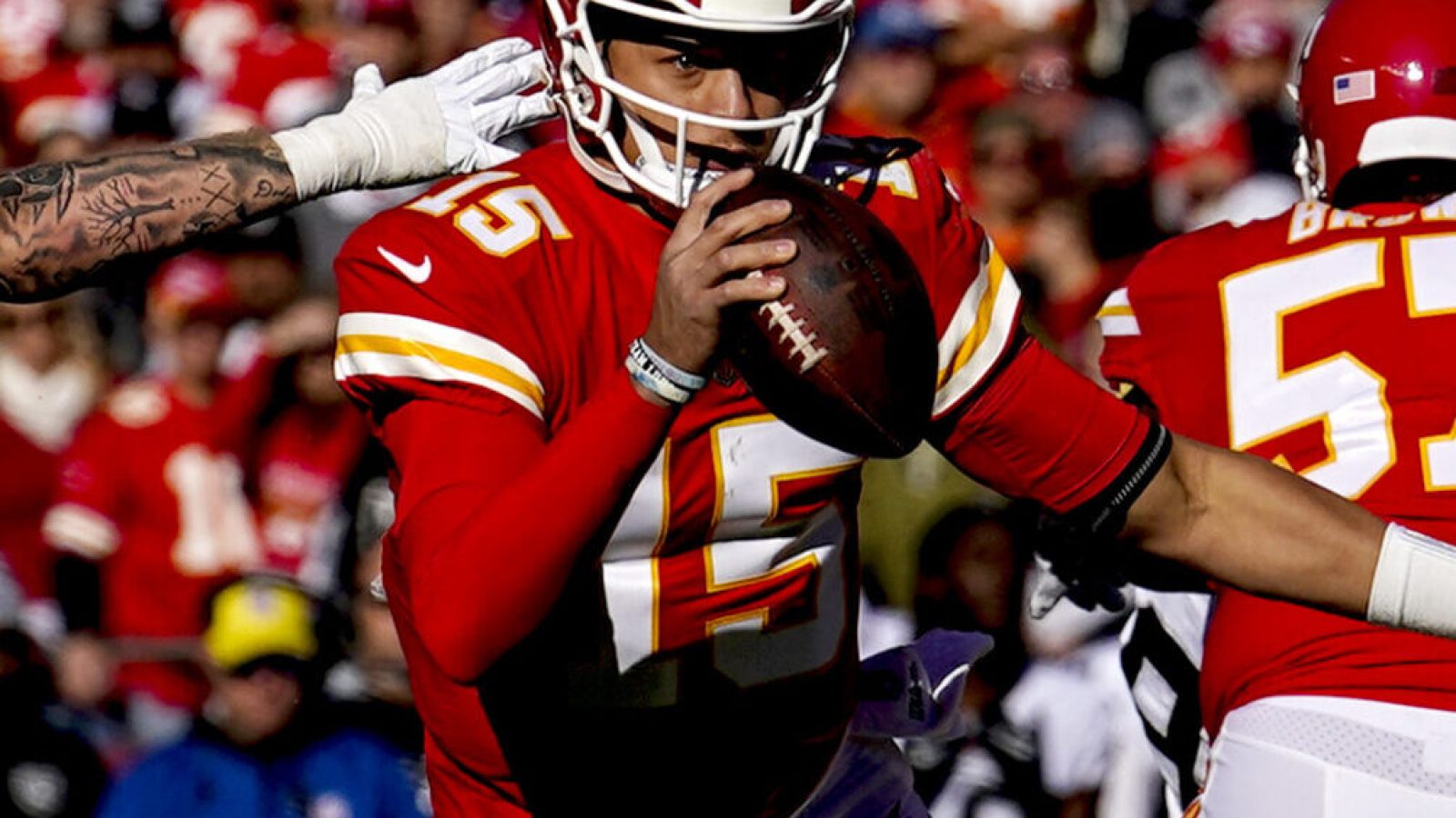 Dec 12, 2021; Kansas City, Missouri, USA; Kansas City Chiefs quarterback Patrick Mahomes (15) scrambles as Las Vegas Raiders defensive end Maxx Crosby (98) defends during the first half at GEHA Field at Arrowhead Stadium.