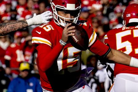 Dec 12, 2021; Kansas City, Missouri, USA; Kansas City Chiefs quarterback Patrick Mahomes (15) scrambles as Las Vegas Raiders defensive end Maxx Crosby (98) defends during the first half at GEHA Field at Arrowhead Stadium.