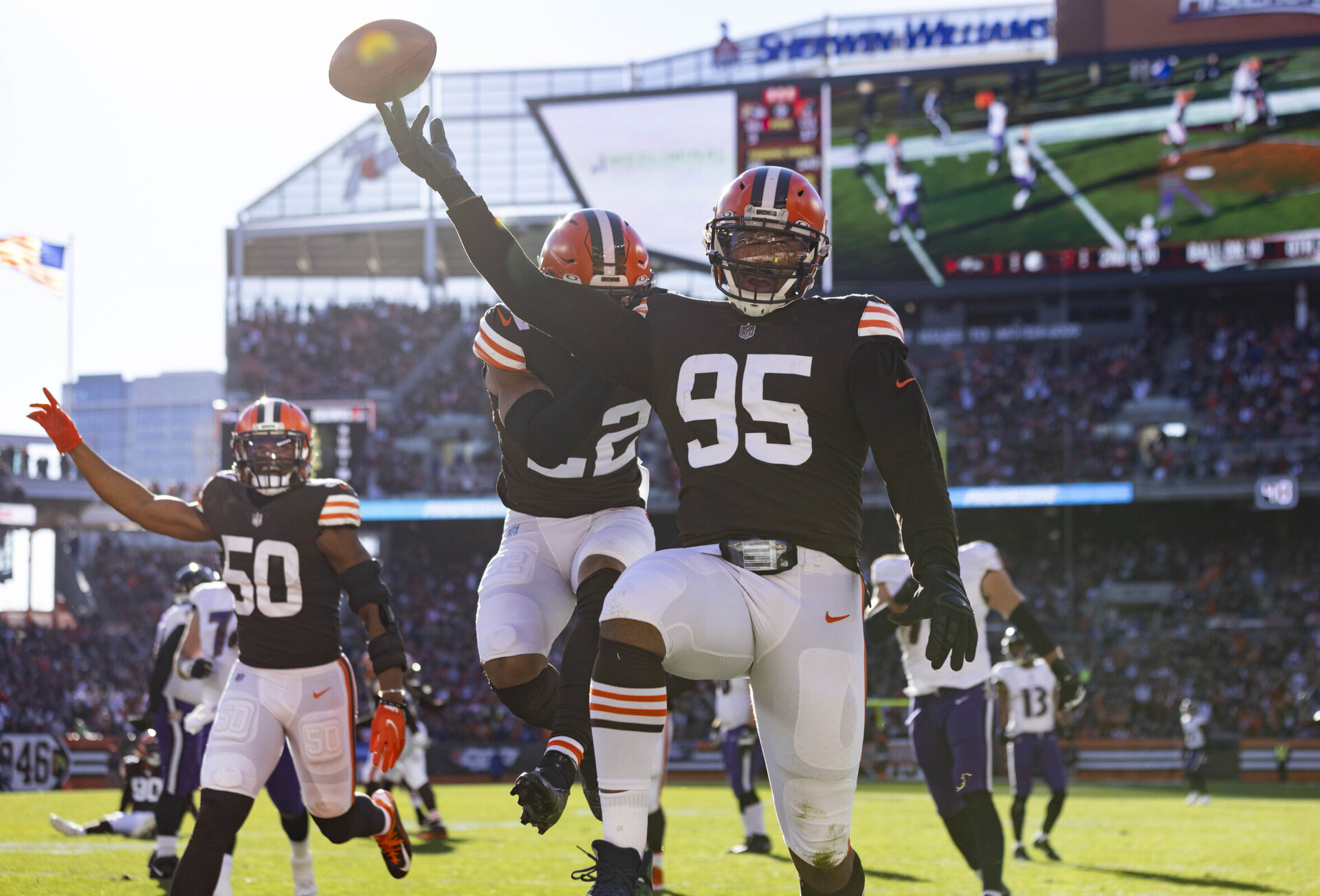 Cleveland Browns defensive end Myles Garrett (95) flips the football as he celebrates his touchdown against the Baltimore Ravens