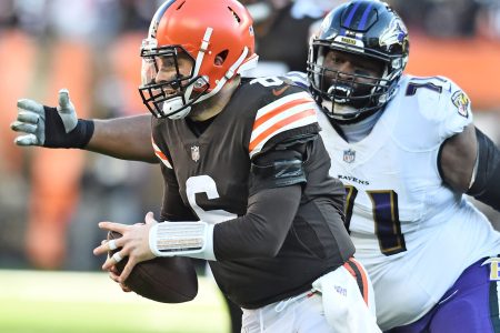 Baltimore Ravens nose tackle Justin Ellis (right) chases Cleveland Browns quarterback Baker Mayfield (left) during a game