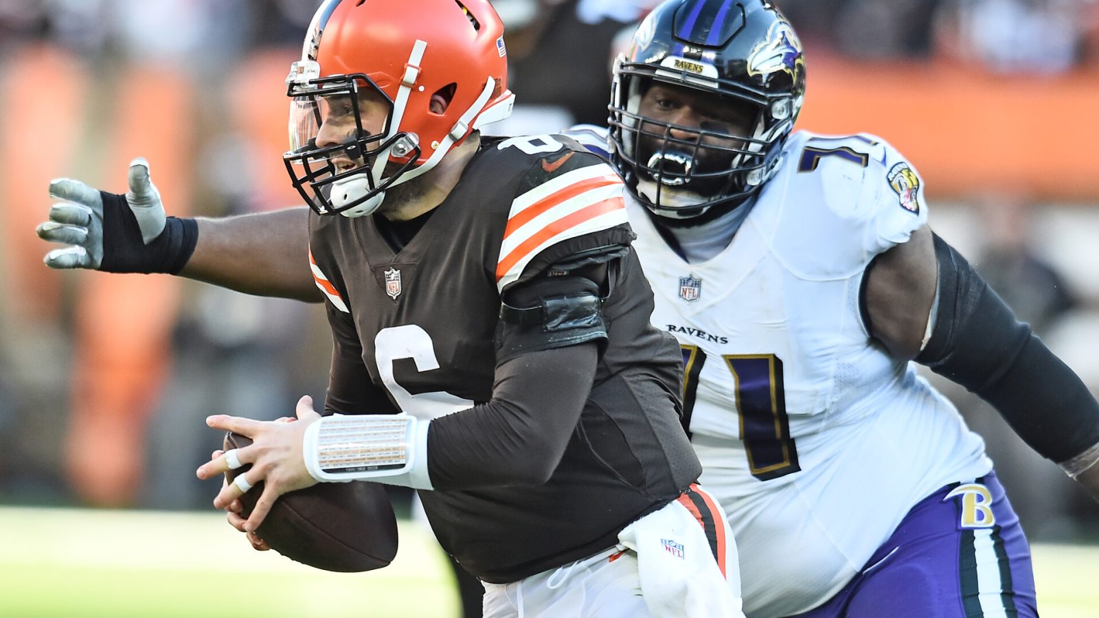 Dec 12, 2021; Cleveland, Ohio, USA; Baltimore Ravens nose tackle Justin Ellis (71) chases Cleveland Browns quarterback Baker Mayfield (6) during the second half at FirstEnergy Stadium.