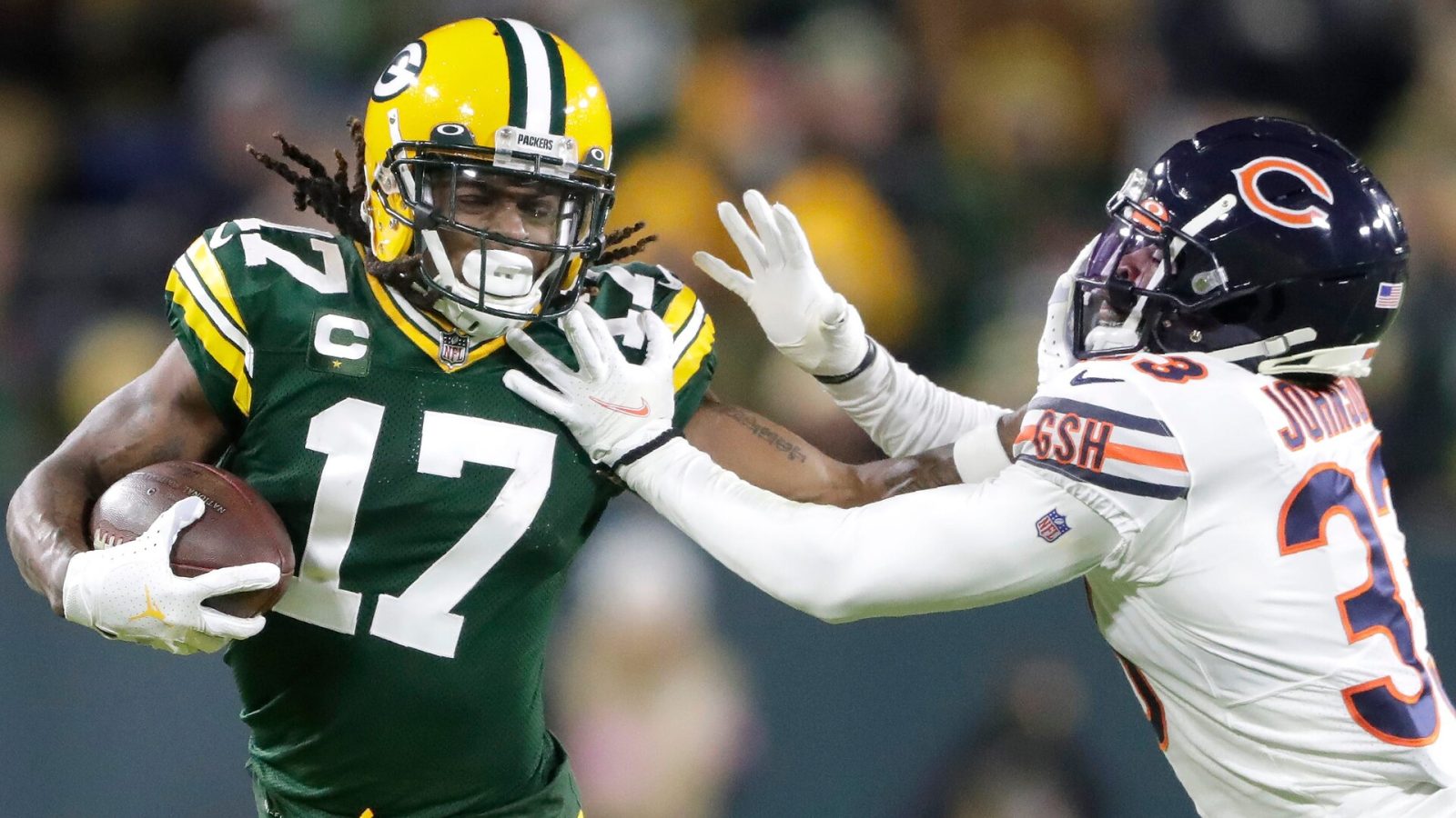 Green Bay Packers wide receiver DaVante Adams stiff-arms Chicago Bears cornerback Jaylon Johnson after making a catch