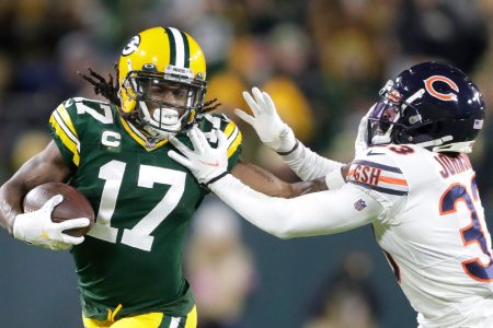 Green Bay Packers wide receiver DaVante Adams stiff-arms Chicago Bears cornerback Jaylon Johnson after making a catch