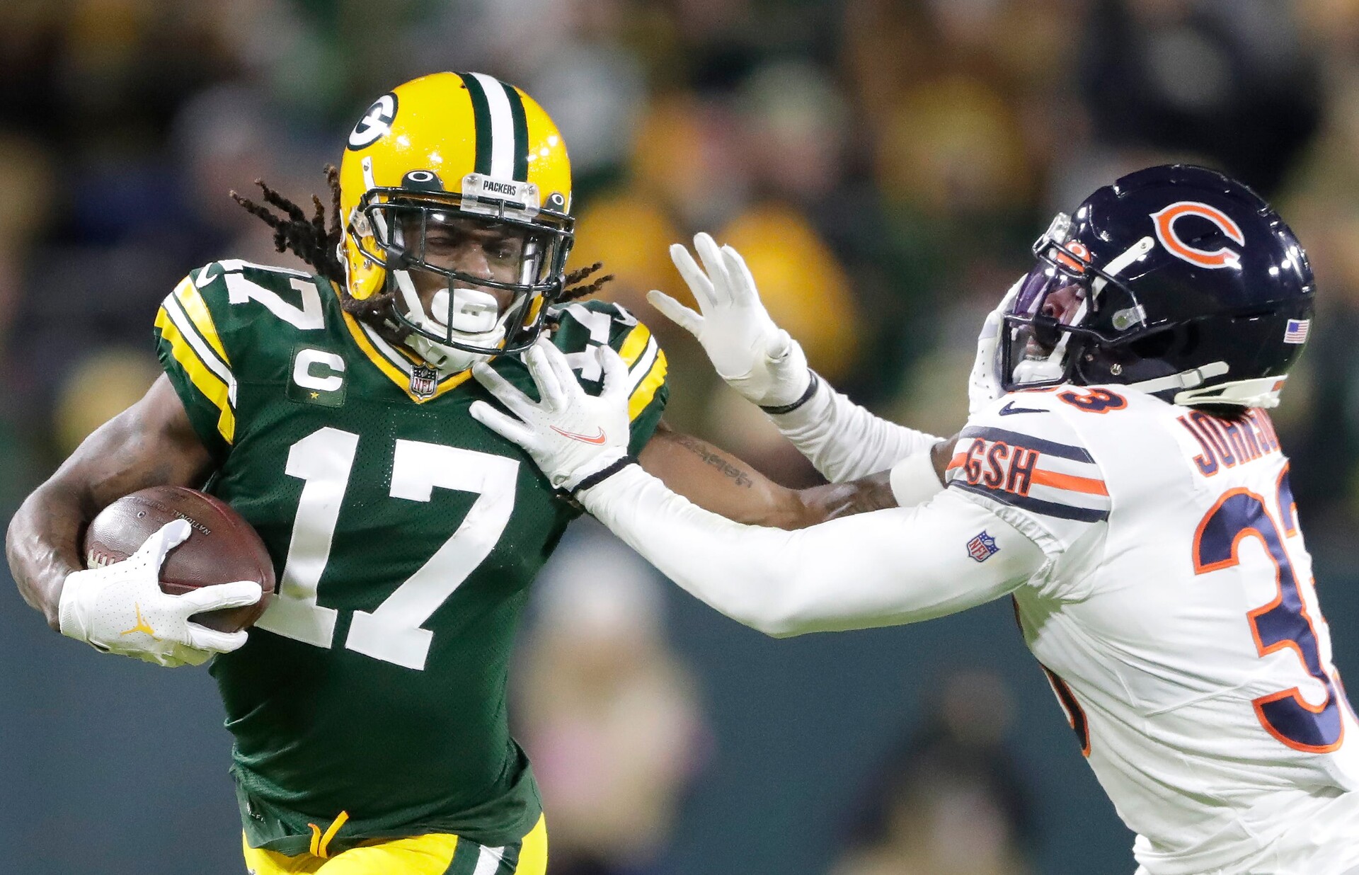 Green Bay Packers wide receiver DaVante Adams stiff-arms Chicago Bears cornerback Jaylon Johnson after making a catch