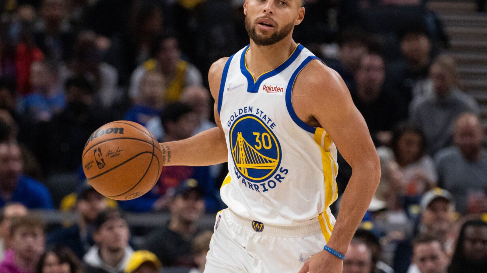 Golden State Warriors guard Stephen Curry dribbles the ball up court in a game against the Indiana Pacers