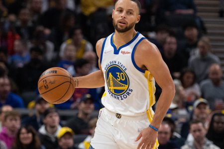 Golden State Warriors guard Stephen Curry dribbles the ball up court in a game against the Indiana Pacers