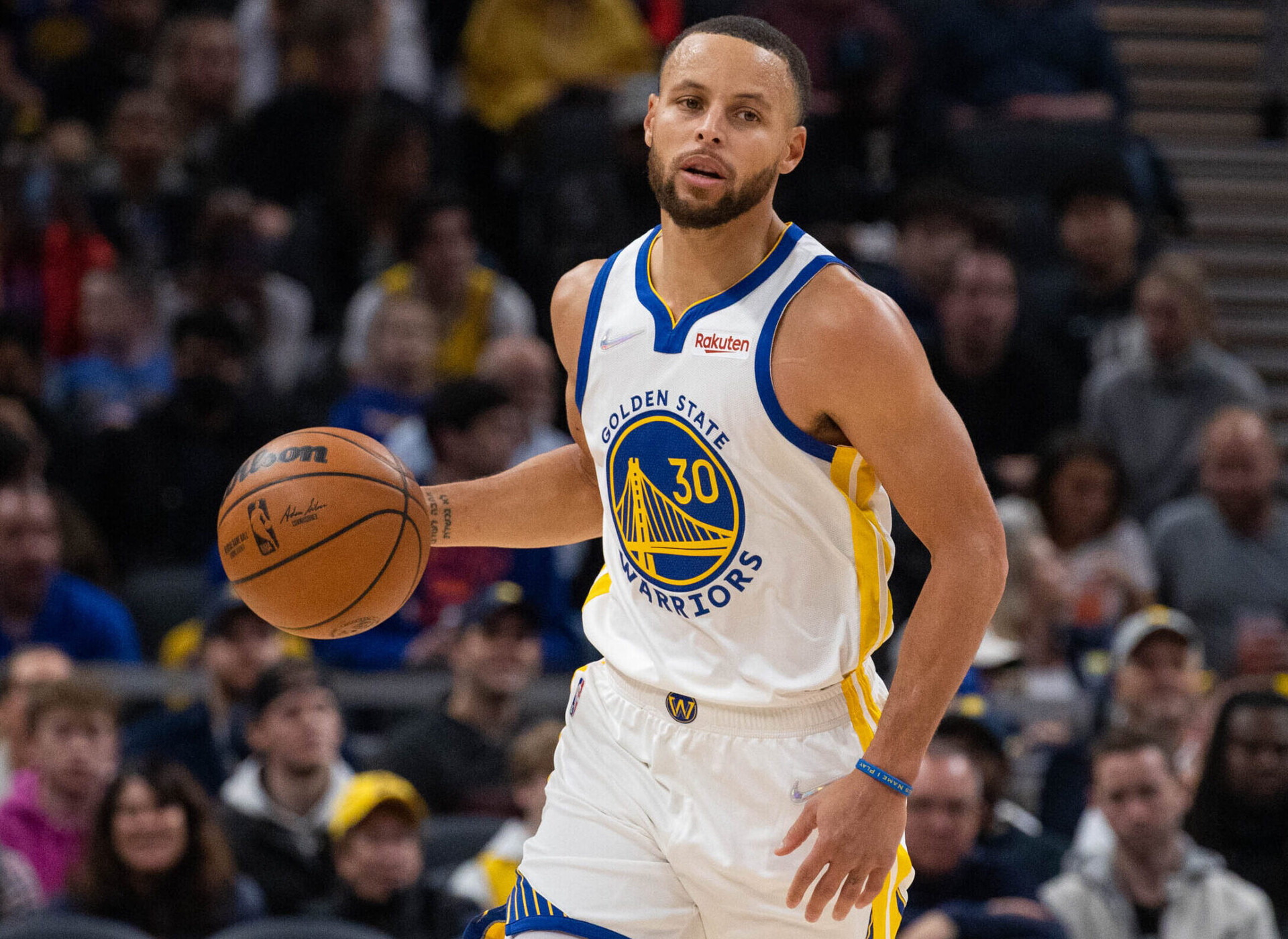 Golden State Warriors guard Stephen Curry dribbles the ball up court in a game against the Indiana Pacers