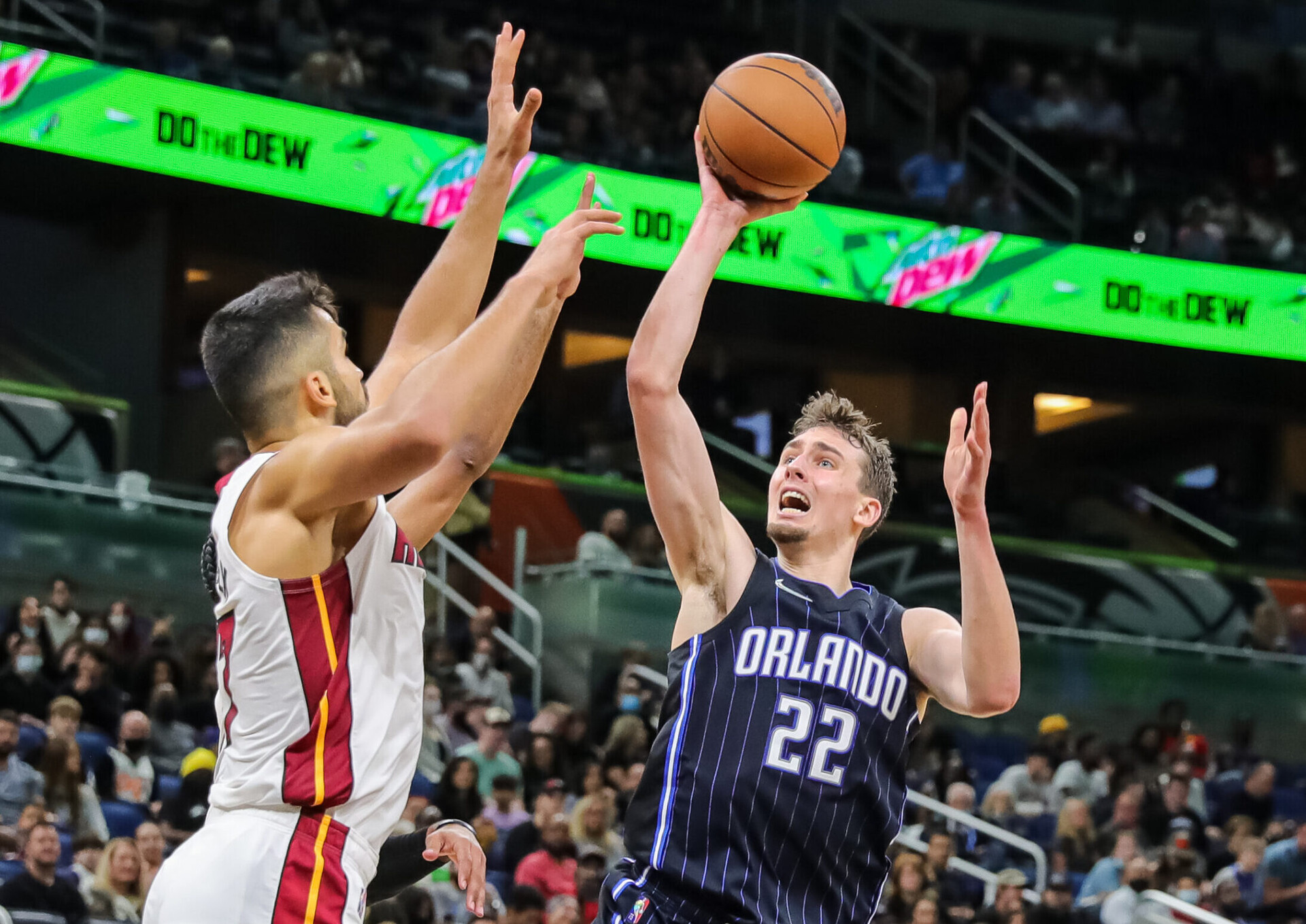Orlando Magic forward Franz Wagner (right) shoots the ball against Miami Heat center Omer Yurtseven (left)