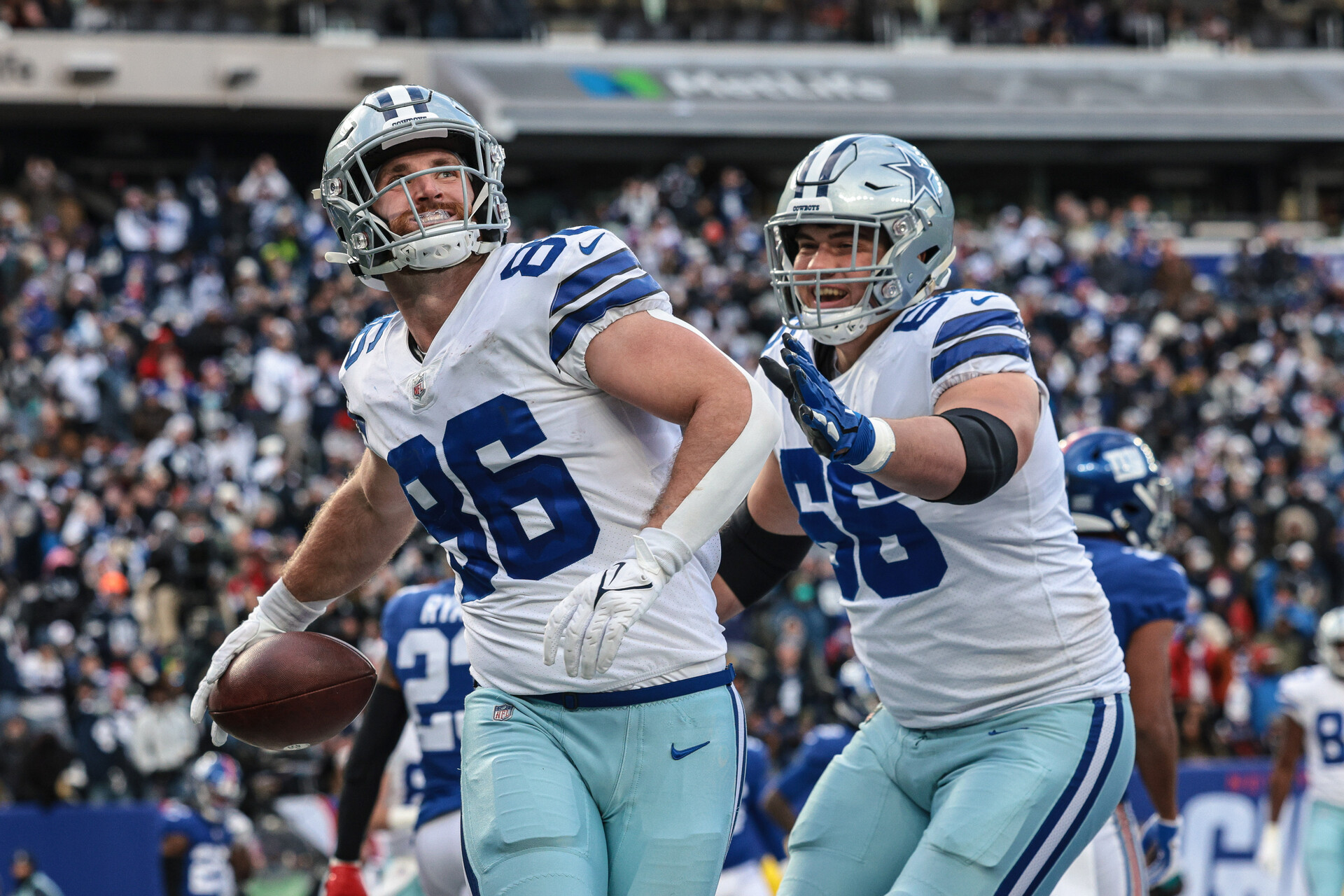 Dallas Cowboys tight end Dalton Schultz (left) celebrates his touchdown reception with guard Connor McGovern (right) during a game against the New York Giants