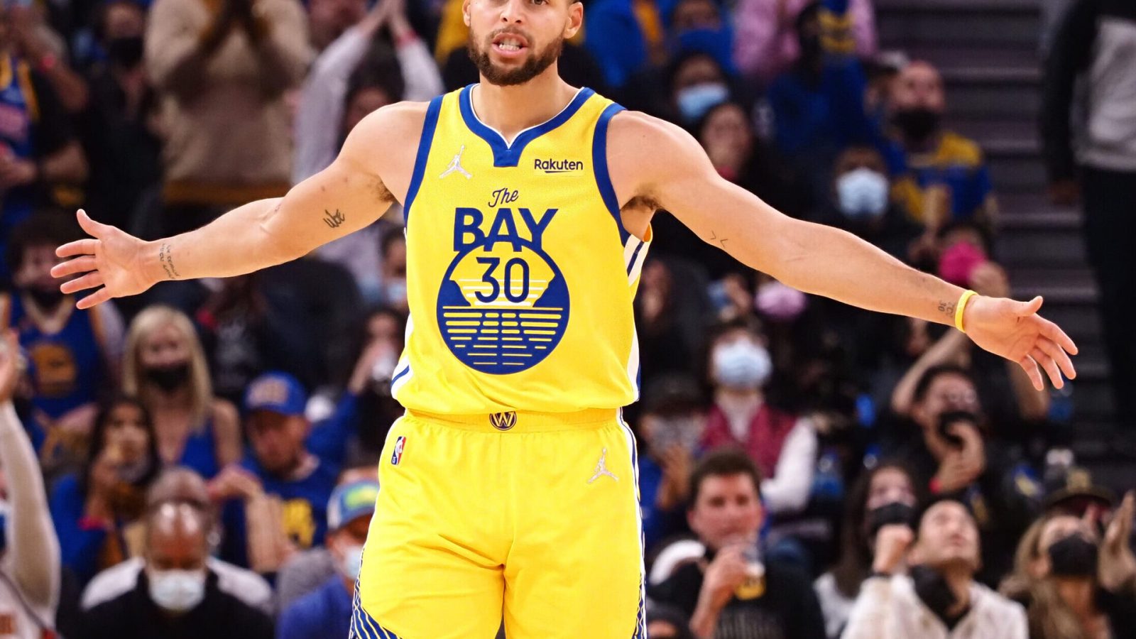 Golden State Warriors guard Stephen Curry celebrates with his arms outstretched after scoring a three-point basket against the Sacramento Kings