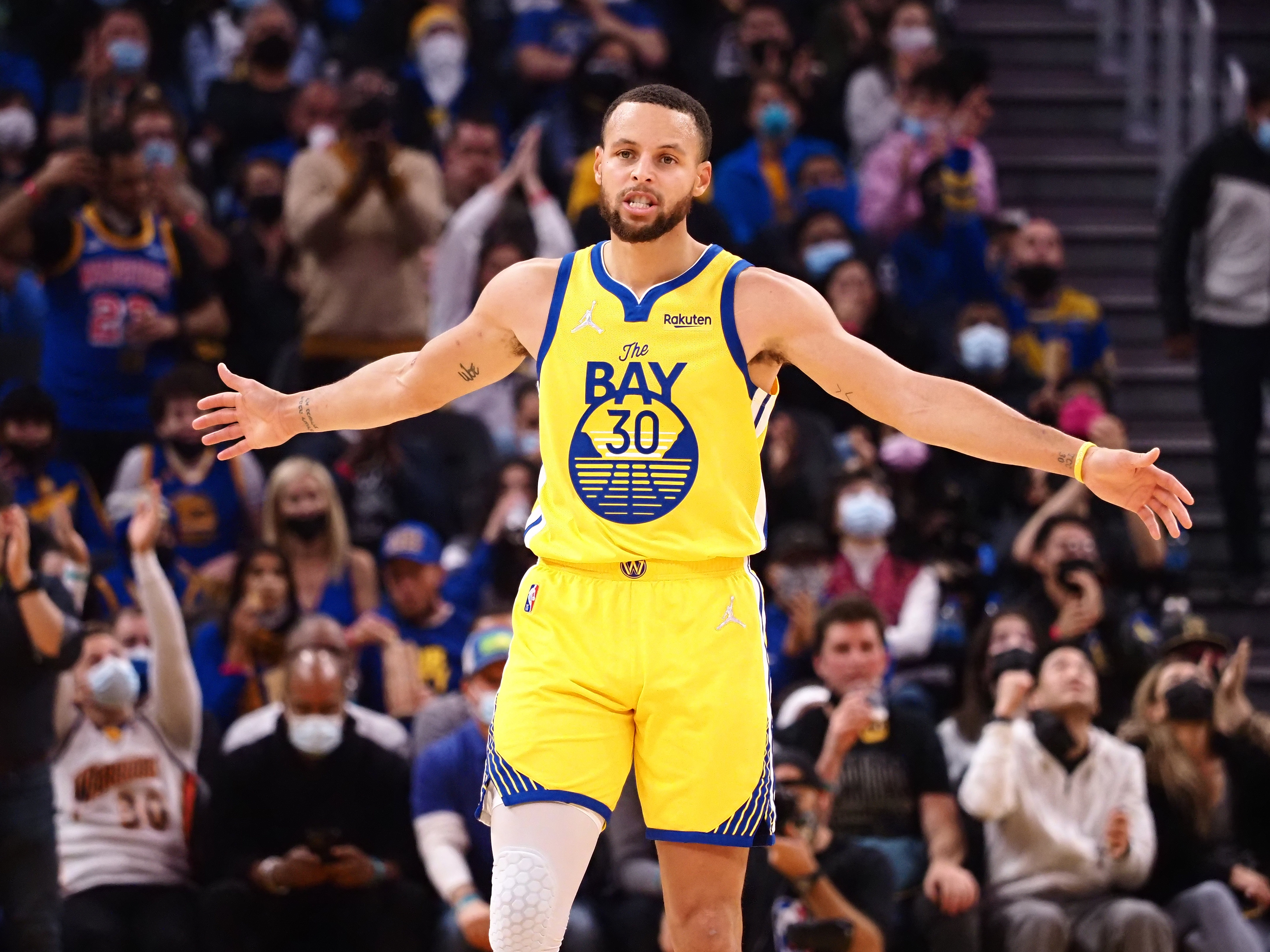 Golden State Warriors guard Stephen Curry celebrates with his arms outstretched after scoring a three-point basket against the Sacramento Kings