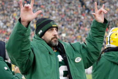 Green Bay Packers quarterback Aaron Rodgers acknowledges the fans after he broke Brett Favre's team record for touchdown passes