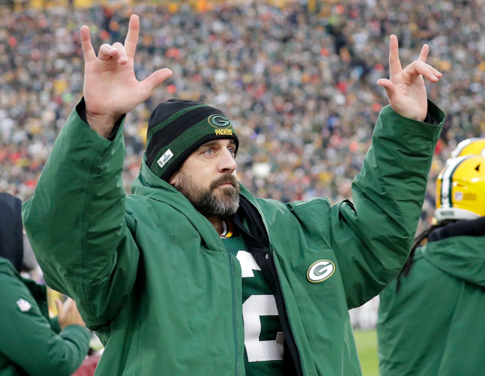 Green Bay Packers quarterback Aaron Rodgers acknowledges the fans after he broke Brett Favre's team record for touchdown passes