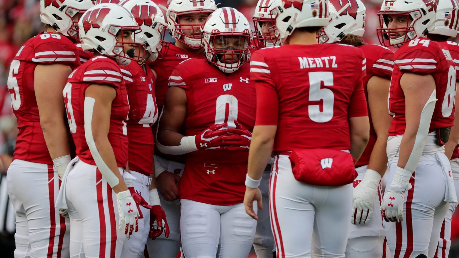 Wisconsin running back Braelon Allen (0) and the rest of the offensive unit listens to quarterback Graham Mertz (5) in the huddle during their game Saturday, November 20, 2021 at Camp Randall Stadium in Madison, Wis. Wisconsin beat Nebraska 35-28. Mjs Uwgrid21 24 Jpg Uwgrid21