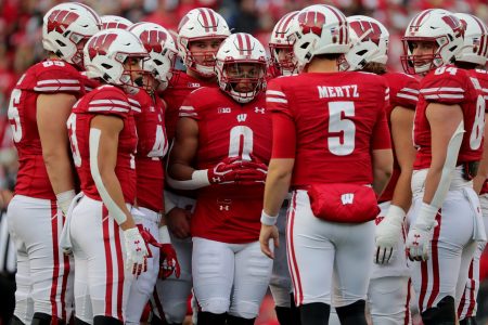 Wisconsin running back Braelon Allen (0) and the rest of the offensive unit listens to quarterback Graham Mertz (5) in the huddle during their game Saturday, November 20, 2021 at Camp Randall Stadium in Madison, Wis. Wisconsin beat Nebraska 35-28. Mjs Uwgrid21 24 Jpg Uwgrid21
