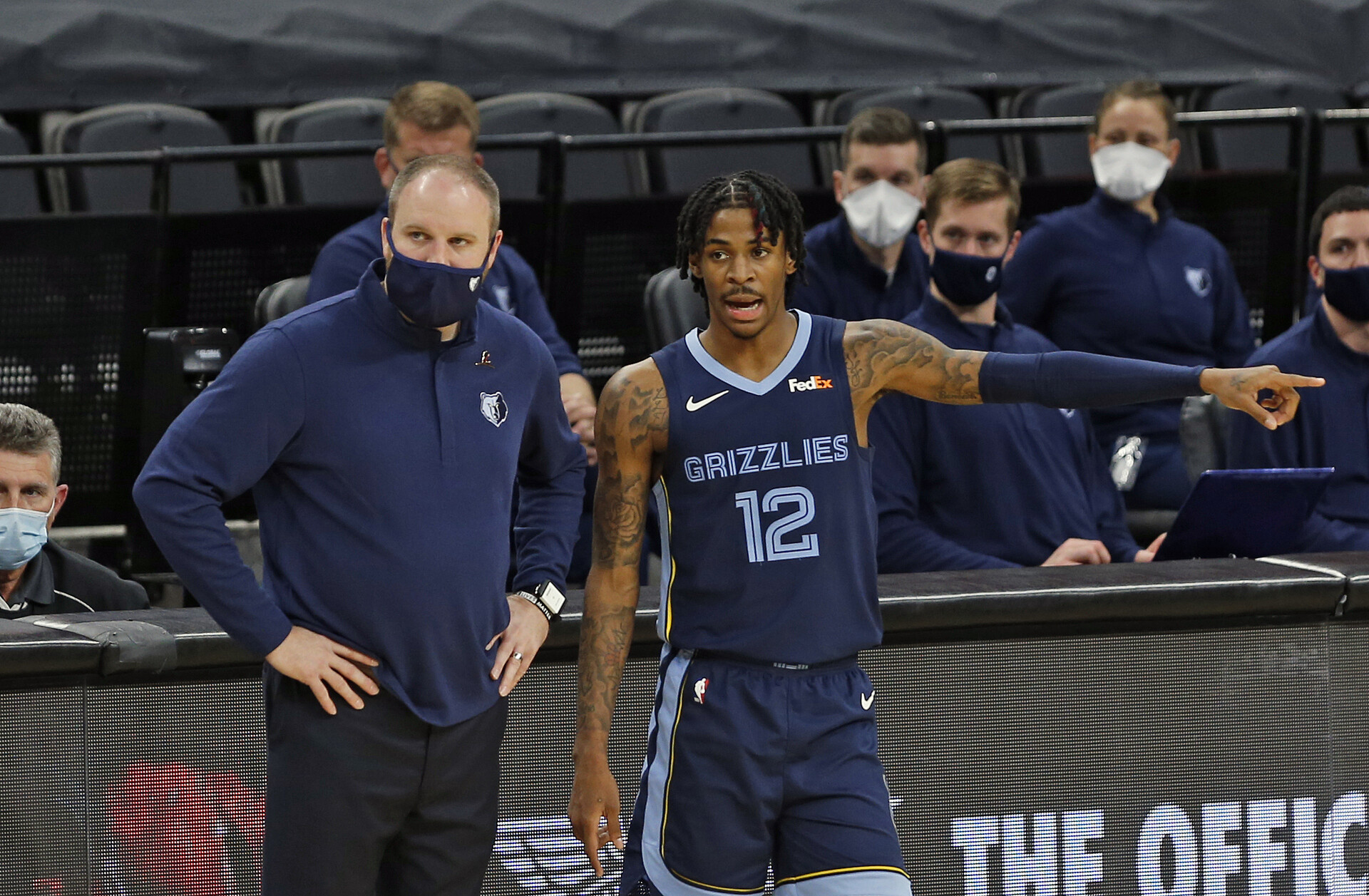 Ja Morant #12 of the Memphis Grizzlies confers with Head coach Taylor Jenkins in the second half at AT&T Center on February 1, 2021 in San Antonio, Texas.