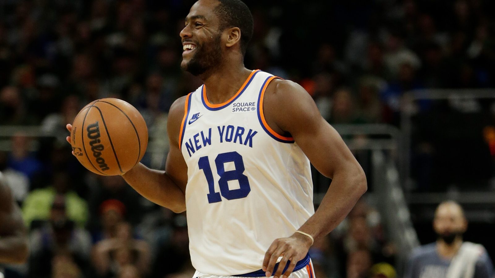Alec Burks #18 of the New York Knicks smiles as he brings the ball up court in the final minutes of the game at Fiserv Forum on November 05, 2021 in Milwaukee, Wisconsin. Knicks defeated the Bucks 113-98.