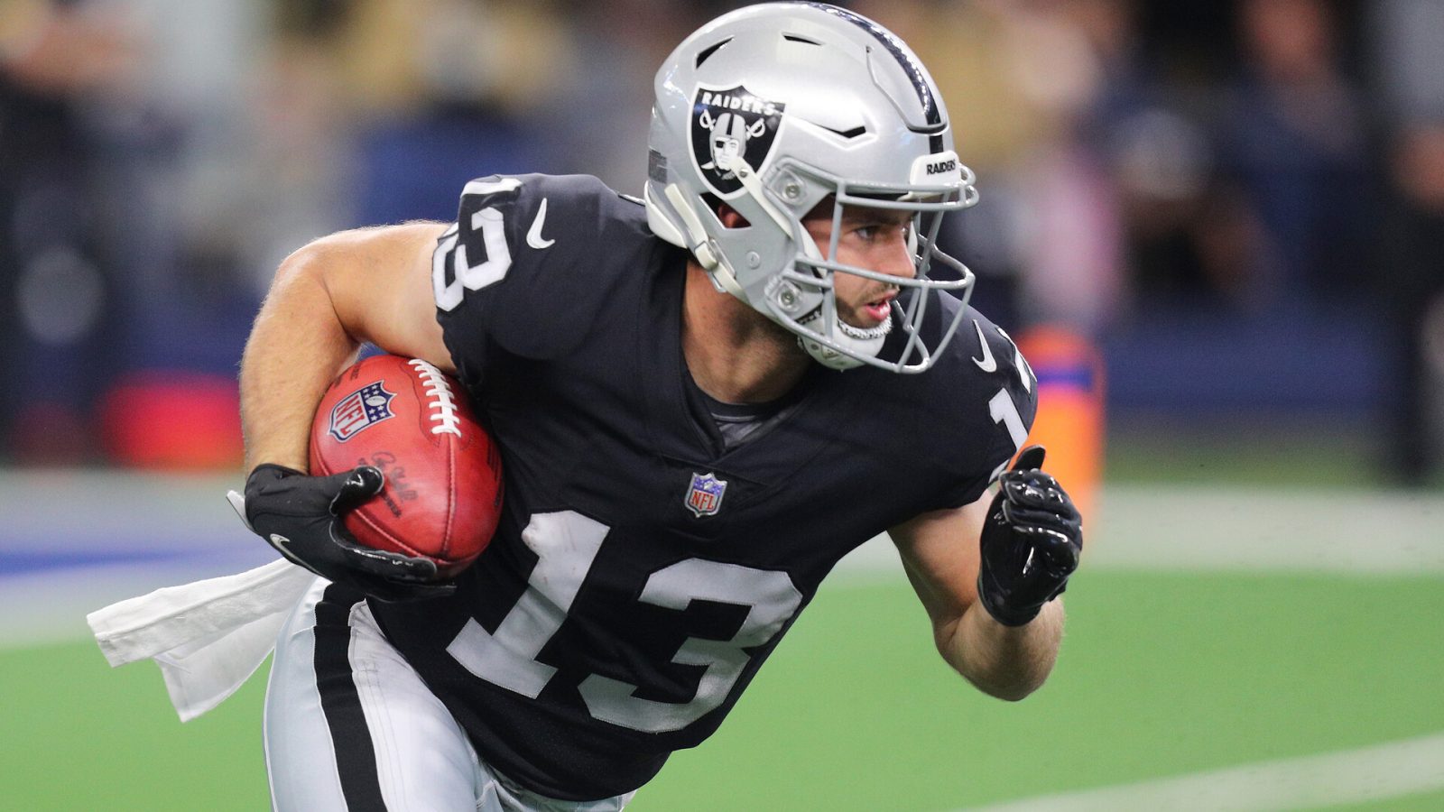 Hunter Renfrow #13 of the Las Vegas Raiders carries the ball after a punt return during the first quarter of the NFL game between Las Vegas Raiders and Dallas Cowboys at AT&T Stadium on November 25, 2021 in Arlington, Texas.