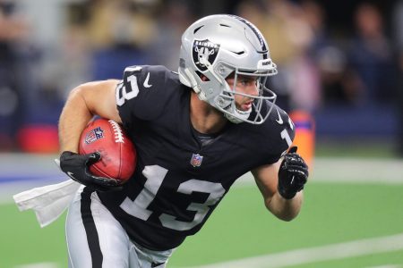 Hunter Renfrow #13 of the Las Vegas Raiders carries the ball after a punt return during the first quarter of the NFL game between Las Vegas Raiders and Dallas Cowboys at AT&T Stadium on November 25, 2021 in Arlington, Texas.