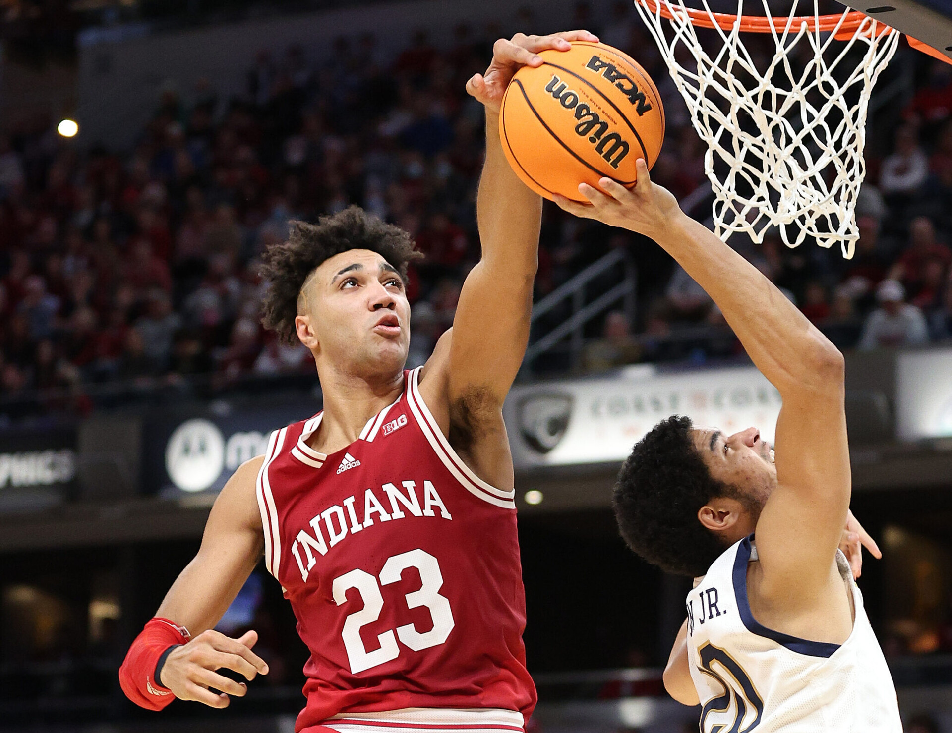 Trayce Jackson-Davis #23 of the Indiana Hoosiers blocks the shot of Paul Atkinson Jr #20 of the Notre Dame Fighting Irish during the 2021 Crossroads Classic at Gainbridge Fieldhouse on December 18, 2021 in Indianapolis, Indiana. 