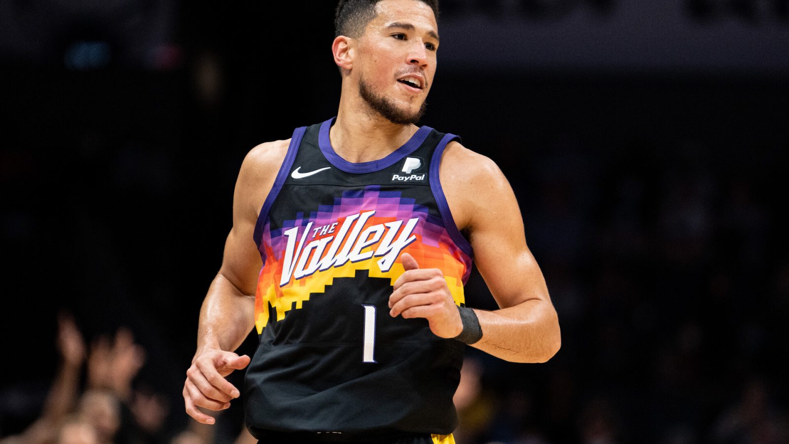 Devin Booker #1 of the Phoenix Suns reacts after making a shot against the Charlotte Hornets in the first quarter during their game at Spectrum Center on January 02, 2022 in Charlotte, North Carolina.