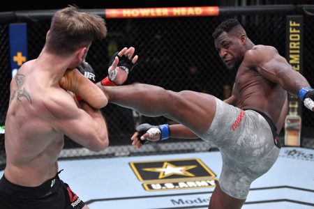 Mar 27, 2021; Las Vegas, NV, USA; Francis Ngannou of Cameroon kicks Stipe Miocic in their UFC heavyweight championship fight during the UFC 260 event at UFC APEX on March 27, 2021 in Las Vegas, Nevada. Mandatory Credit: Jeff Bottari/Handout Photo via USA TODAY Sports
